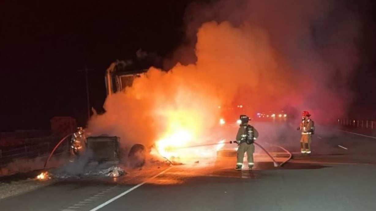 Hurricane Valley Fire and Rescue firefighters extinguish the flames after a tractor-trailer caught fire, Leeds, Washington County, Thursday.