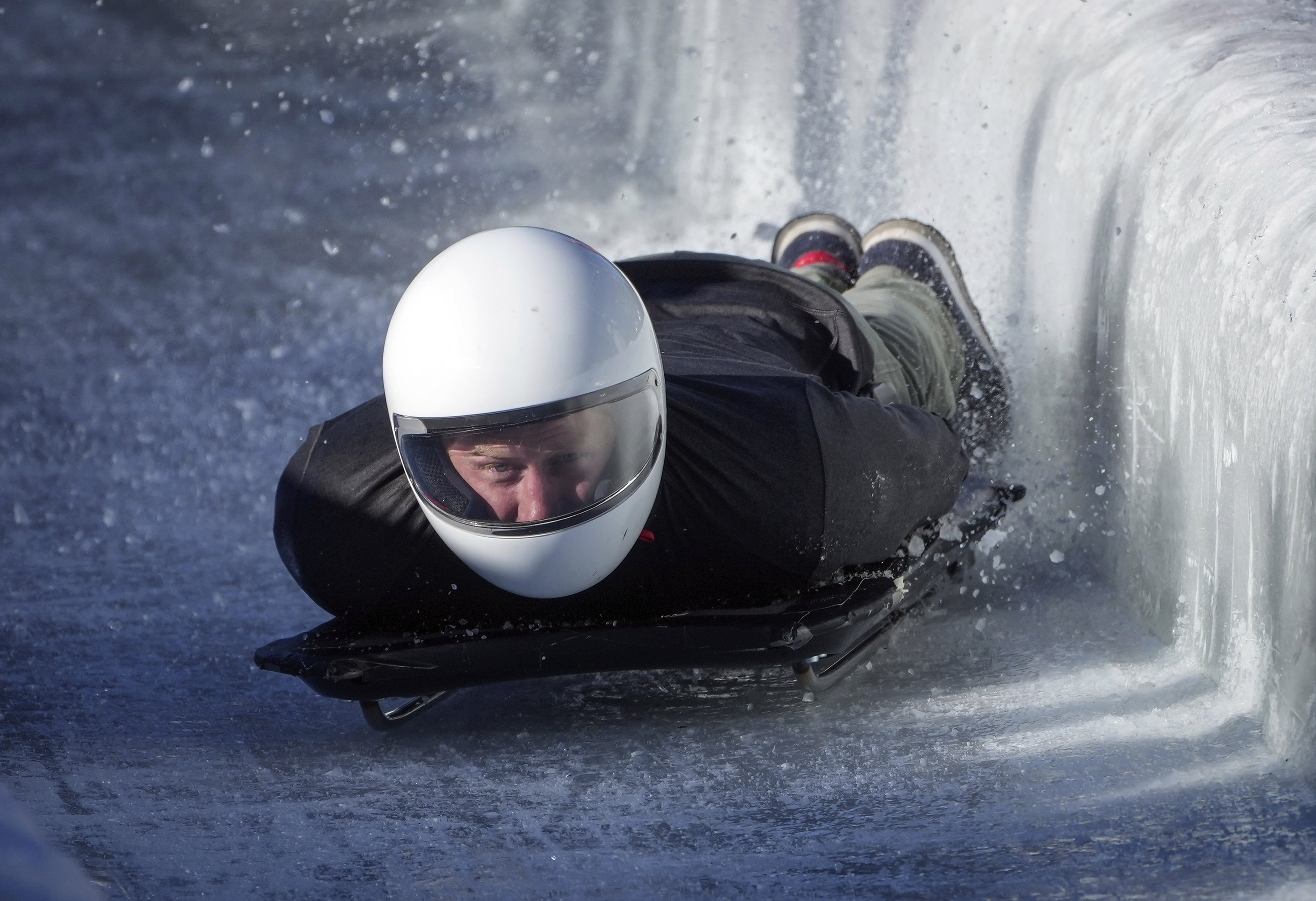 Prince Harry, the Duke of Sussex, hits the wall as he slides down the track on a skeleton sled during an Invictus Games training camp, in Whistler, British Columbia, Thursday, Feb. 15, 2024. Invictus Games Vancouver Whistler 2025 is scheduled to take place from Feb. 8 to 16, 2025 and will for the first time feature winter sports.