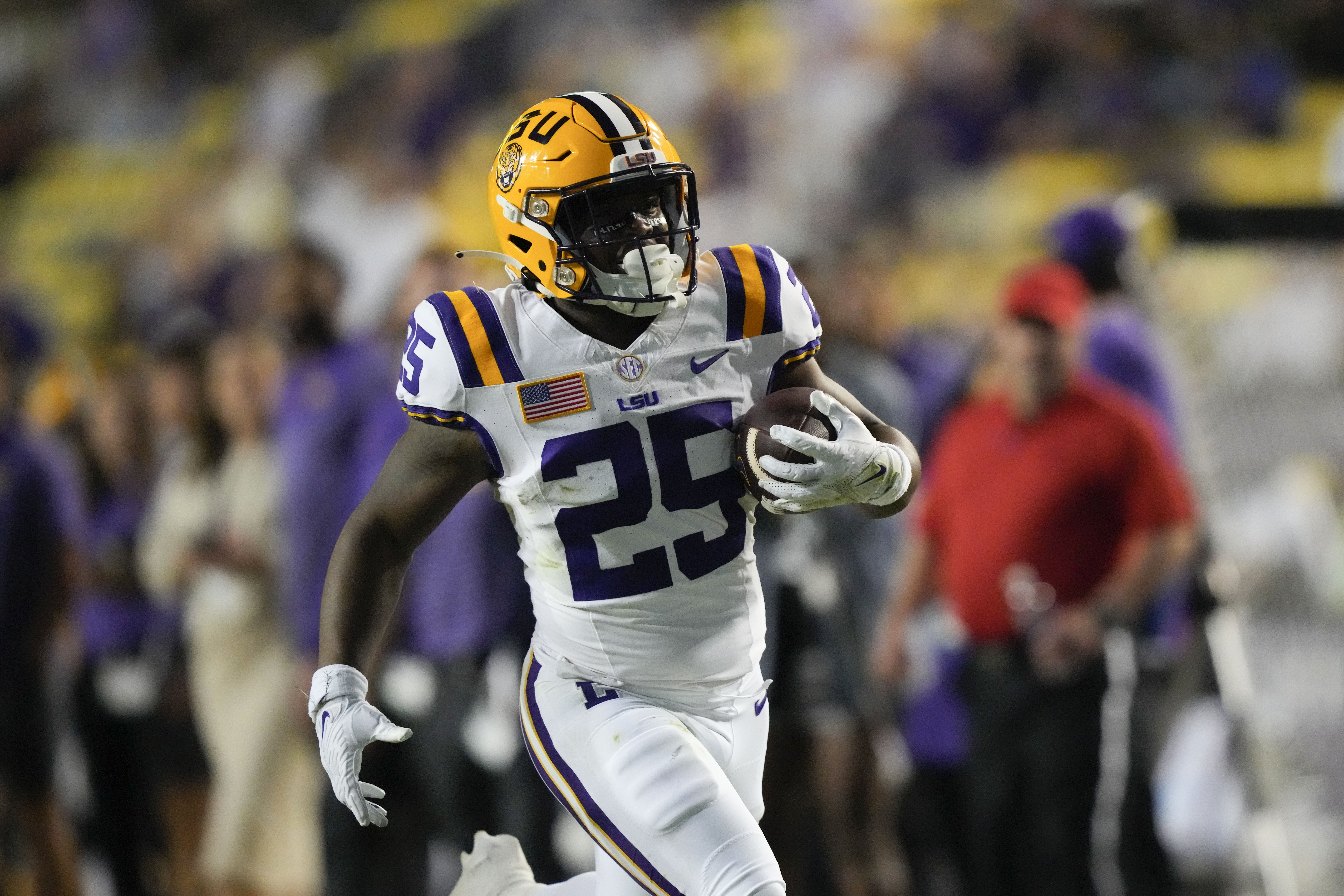 FILE - LSU running back Trey Holly (25) carries for a touchdown during the second half of the team's NCAA college football game against Army in Baton Rouge, La., Oct. 21, 2023. The LSU freshman was arrested Thursday, Feb. 15, 2024, and charged with attempted second-degree murder and other charges after a shooting last week that injured two people. 