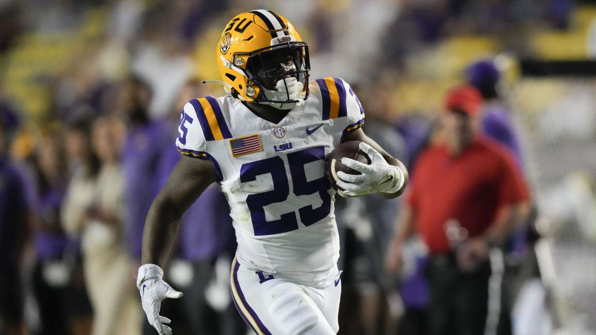 FILE - LSU running back Trey Holly (25) carries for a touchdown during the second half of the team's NCAA college football game against Army in Baton Rouge, La., Oct. 21, 2023. The LSU freshman was arrested Thursday, Feb. 15, 2024, and charged with attempted second-degree murder and other charges after a shooting last week that injured two people.