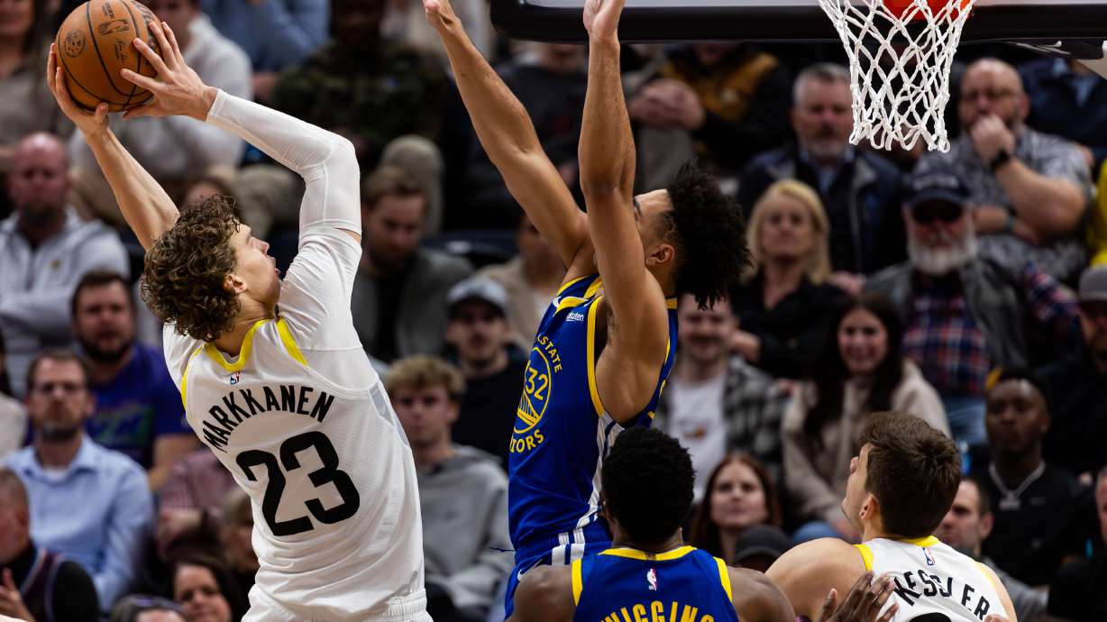 Utah Jazz forward Lauri Markkanen (23) shoots the ball with Golden State Warriors forward Trayce Jackson-Davis (32) on defense during the NBA basketball game between the Utah Jazz and the Golden State Warriors at the Delta Center in Salt Lake City on Thursday, Feb. 15, 2024.