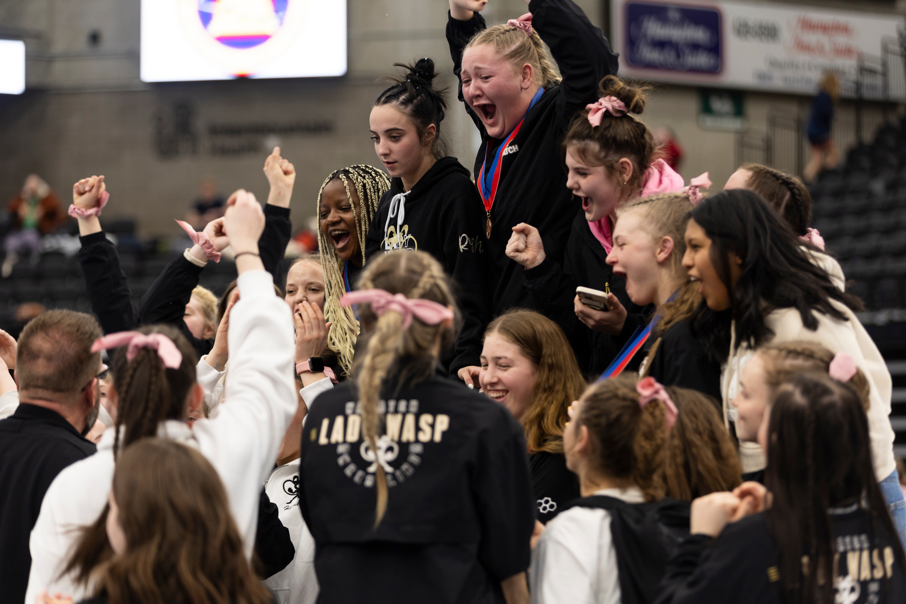 Wasatch High School celebrates a first place win during the 5A Girls Wrestling State Championships at the UCCU Center in Orem on Thursday, Feb. 15, 2024.
