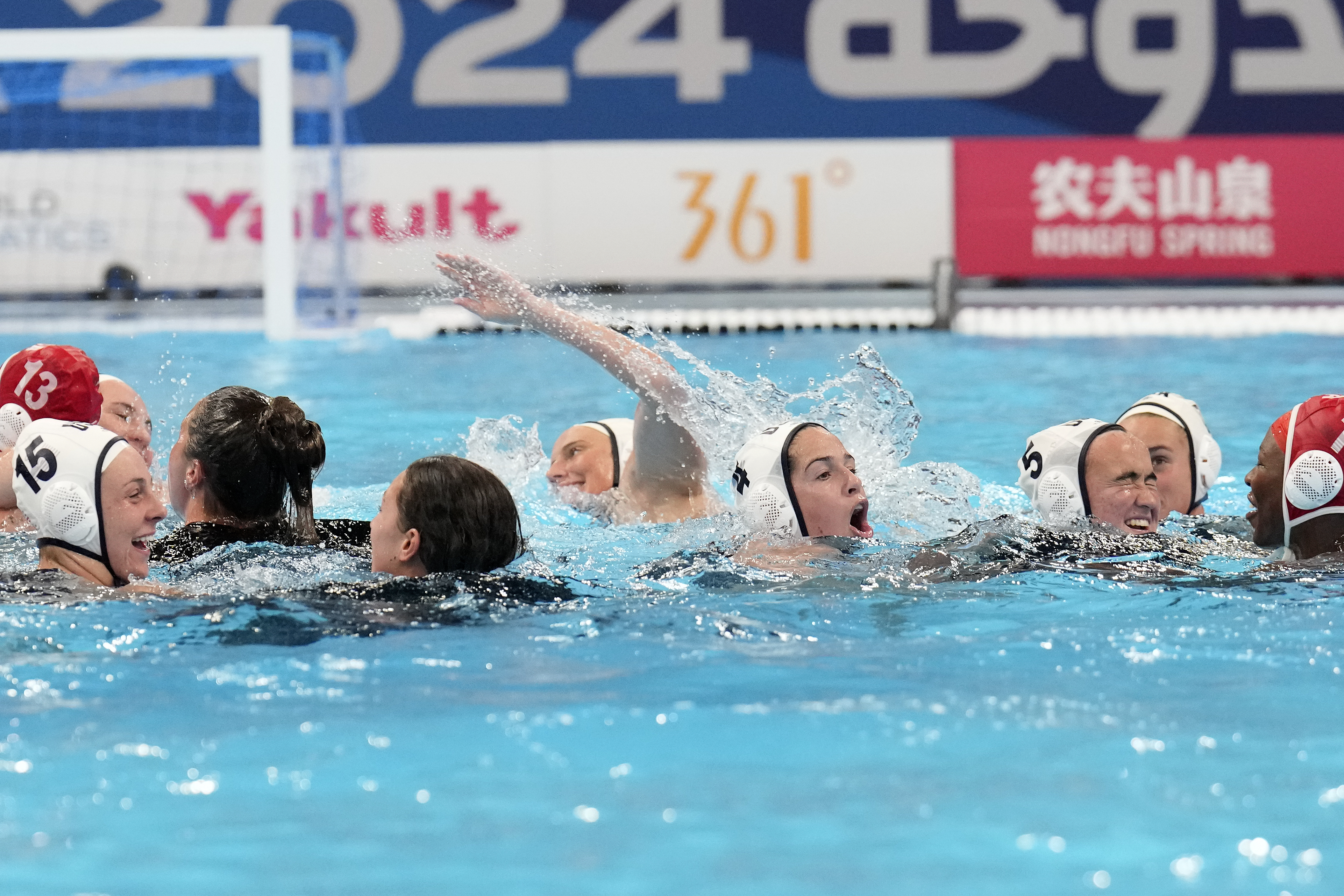 Players from the United States celebrate their victory over Hungary during the women's water polo final at the World Aquatics Championships in Doha, Qatar, Friday, Feb. 16, 2024.