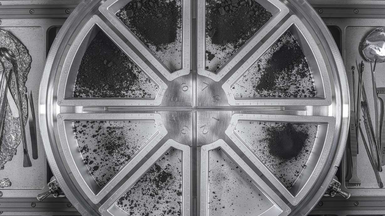 This photo shows eight sample trays containing the final material from asteroid Bennu. NASA reported Thursday that the Osiris-Rex spacecraft collected 4.3 ounces of dust and pebbles from asteroid Bennu.