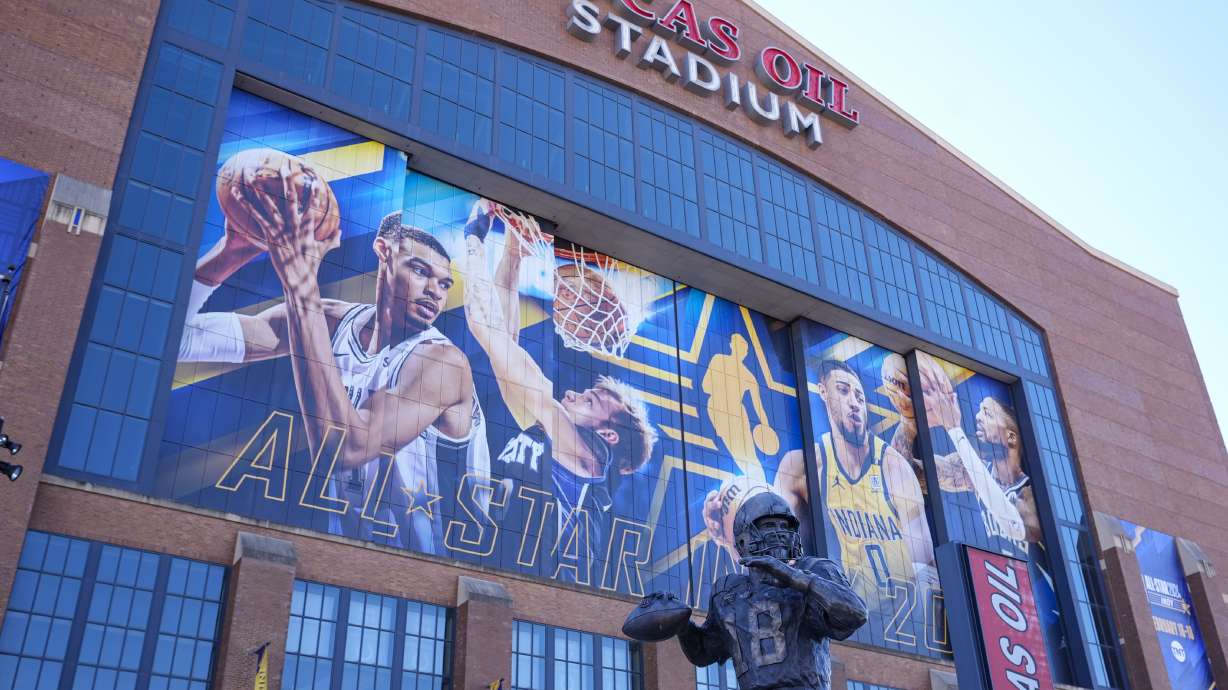 A statue of Indianapolis Colts quarterback Peyton Manning stand in front of signage promoting the NBA All-Star basketball game on the window on Lucas Oil Stadium in Indianapolis, Wednesday, Feb. 14, 2024. The NBA All-Star game in Sunday.