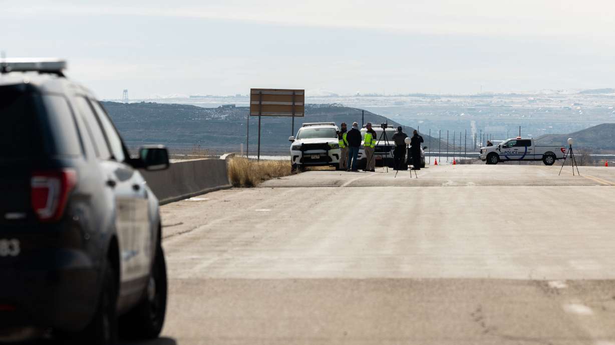 Salt Lake City police and Utah Highway Patrol troopers investigate following an incident at an overpass on 7200 West near I-80 in Salt Lake City on Tuesday.