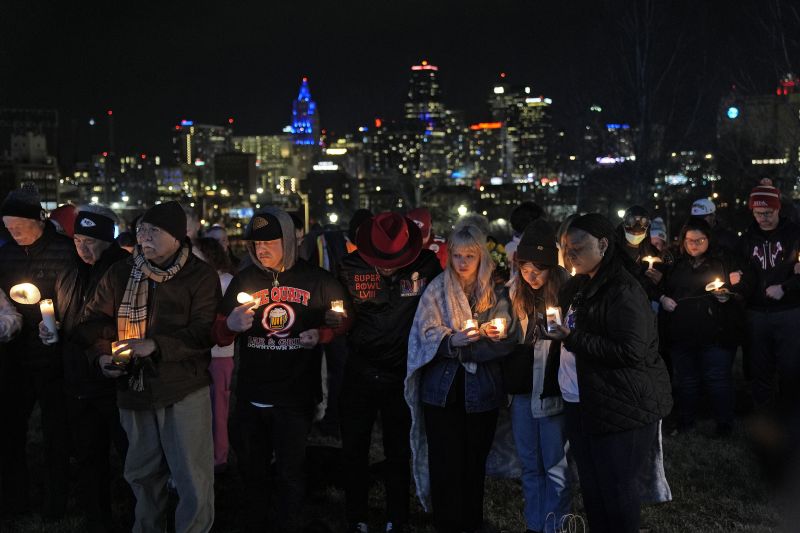 People attend a candlelight vigil for victims of a shooting at a Kansas City Chiefs Super Bowl victory rally Thursday in Kansas City, Mo. More than 20 people were injured and one woman killed in the shooting near the end of Wednesday's rally held at nearby Union Station.