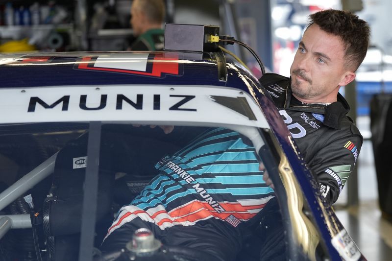 Race car driver and actor Frankie Muniz climbs into his car before a practice run Friday at Daytona International Speedway in Daytona Beach, Fla. Muniz will attempt to make his NASCAR Xfinity Series debut Saturday.