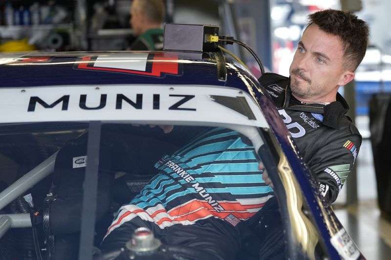Race car driver and actor Frankie Muniz climbs into his car before a practice run Friday at Daytona International Speedway in Daytona Beach, Fla. Muniz will attempt to make his NASCAR Xfinity Series debut Saturday.