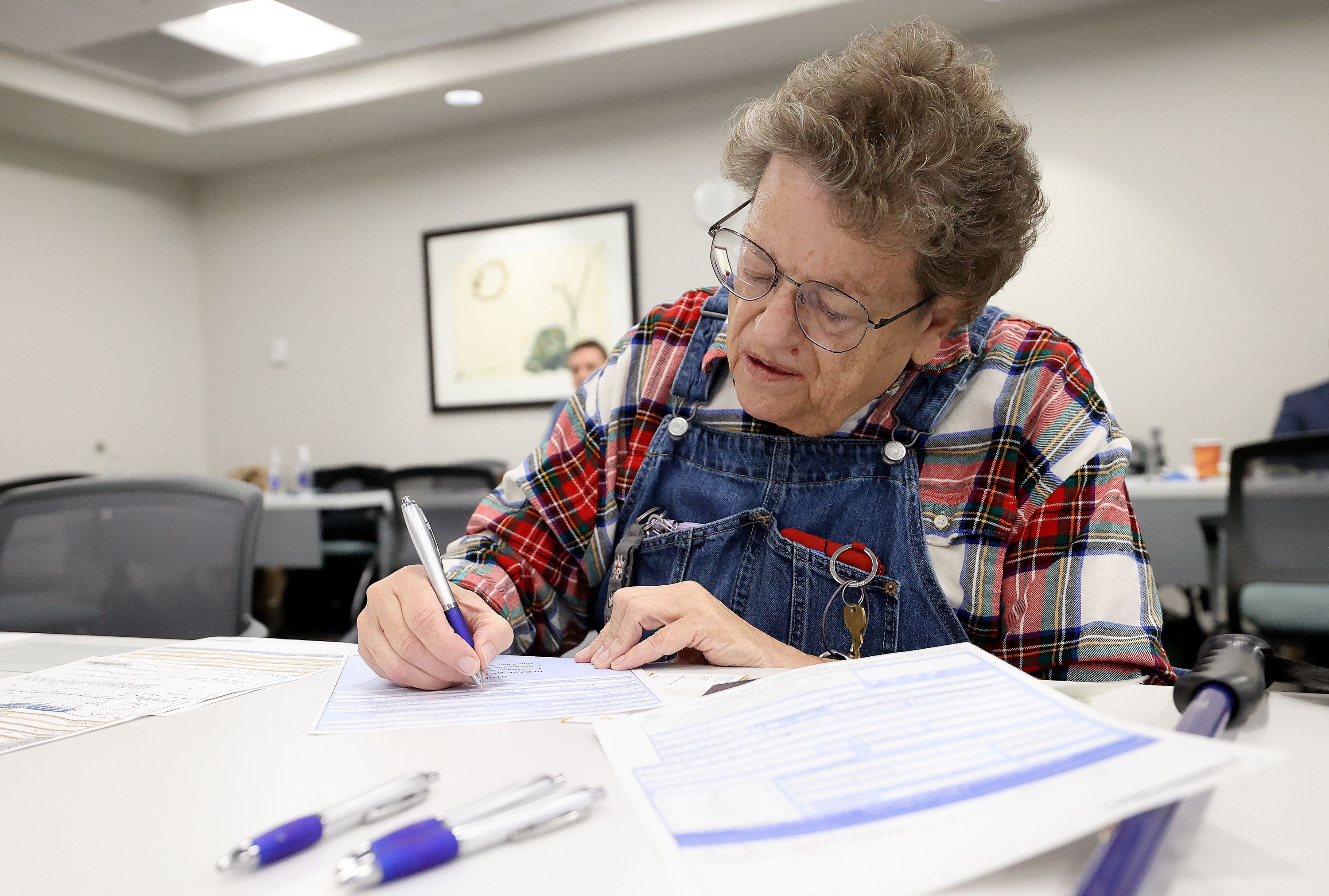 Karen Cravens fills out a passport application at the State Department’s Salt Lake City Passport Fair at the Bennett Federal Building in Salt Lake City on Friday.