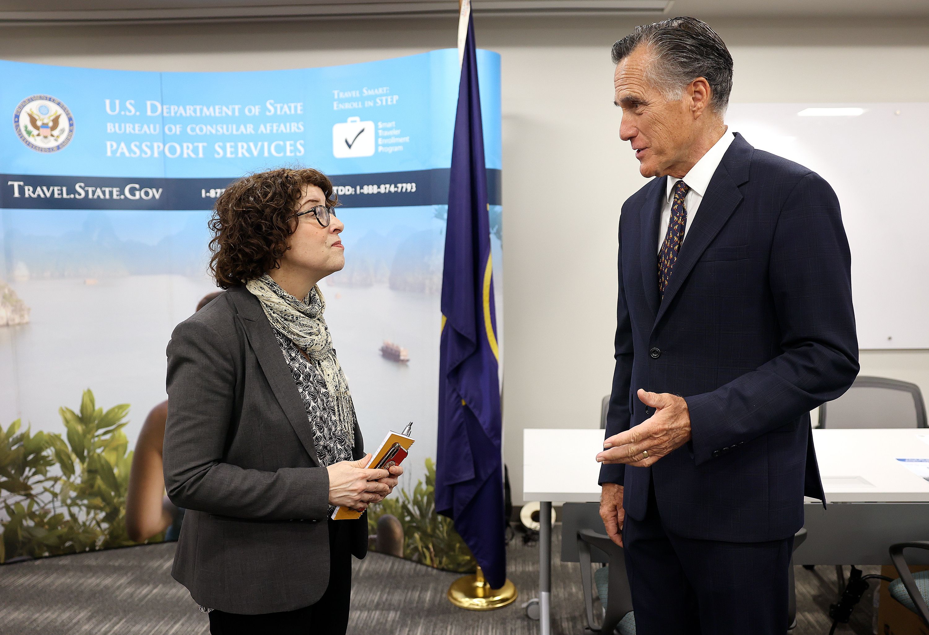 U.S. Assistant Secretary of State for Consular Affairs Rena Bitter and Sen. Mitt Romney, R-Utah, talk while visiting the State Department’s Salt Lake City Passport Fair at the Bennett Federal Building in Salt Lake City on Friday.