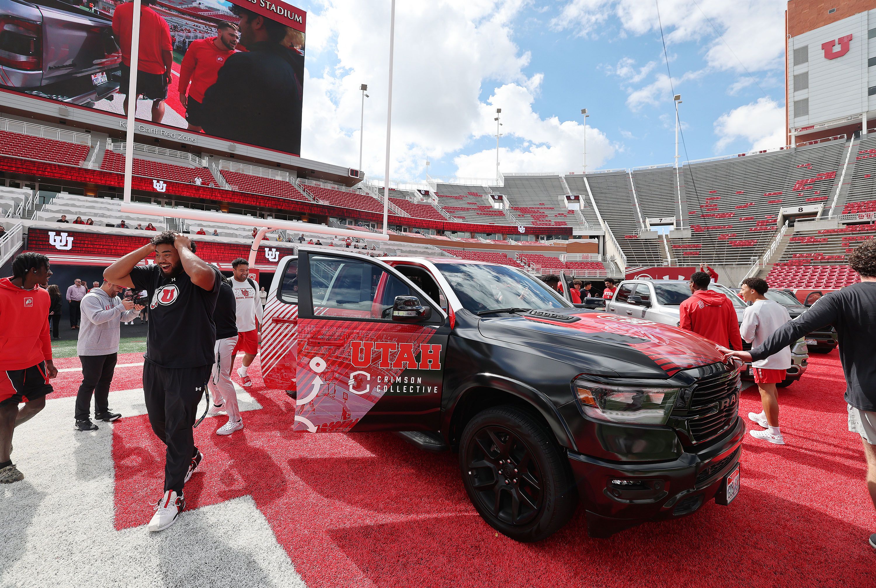 Utah Utes football players look over trucks given to them from the Crimson Collective at Rice-Eccles Stadium in Salt Lake City on Oct. 4, 2023. The Utah House passed a bill Thursday that would exempt college athletes' name, image and likeness agreements submitted to universities for review from the state's public records law.