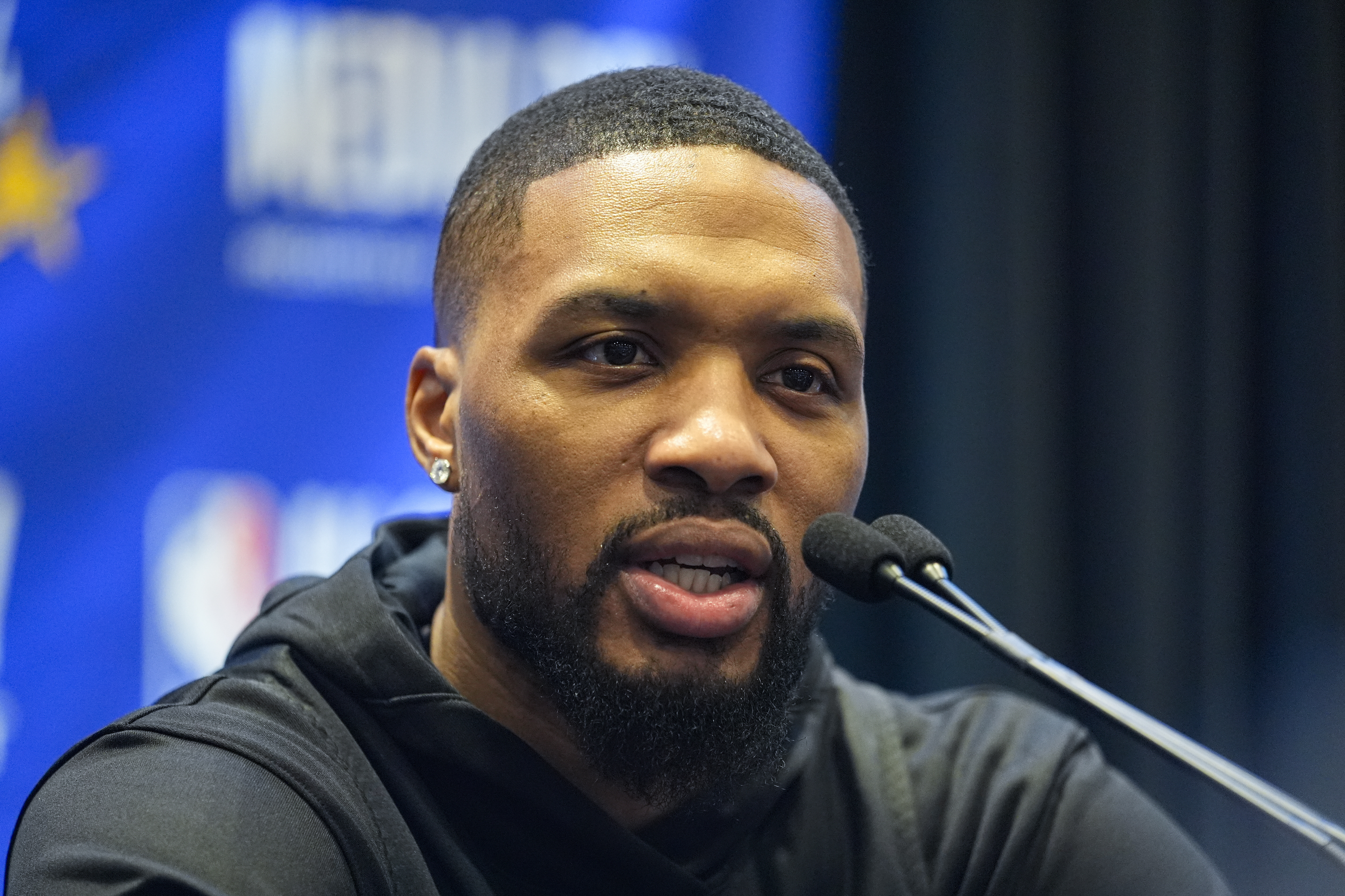 Milwaukee Bucks guard Damian Lillard answers a question during media day at the NBA All-Star basketball game in Indianapolis, Saturday, Feb. 17, 2024. 