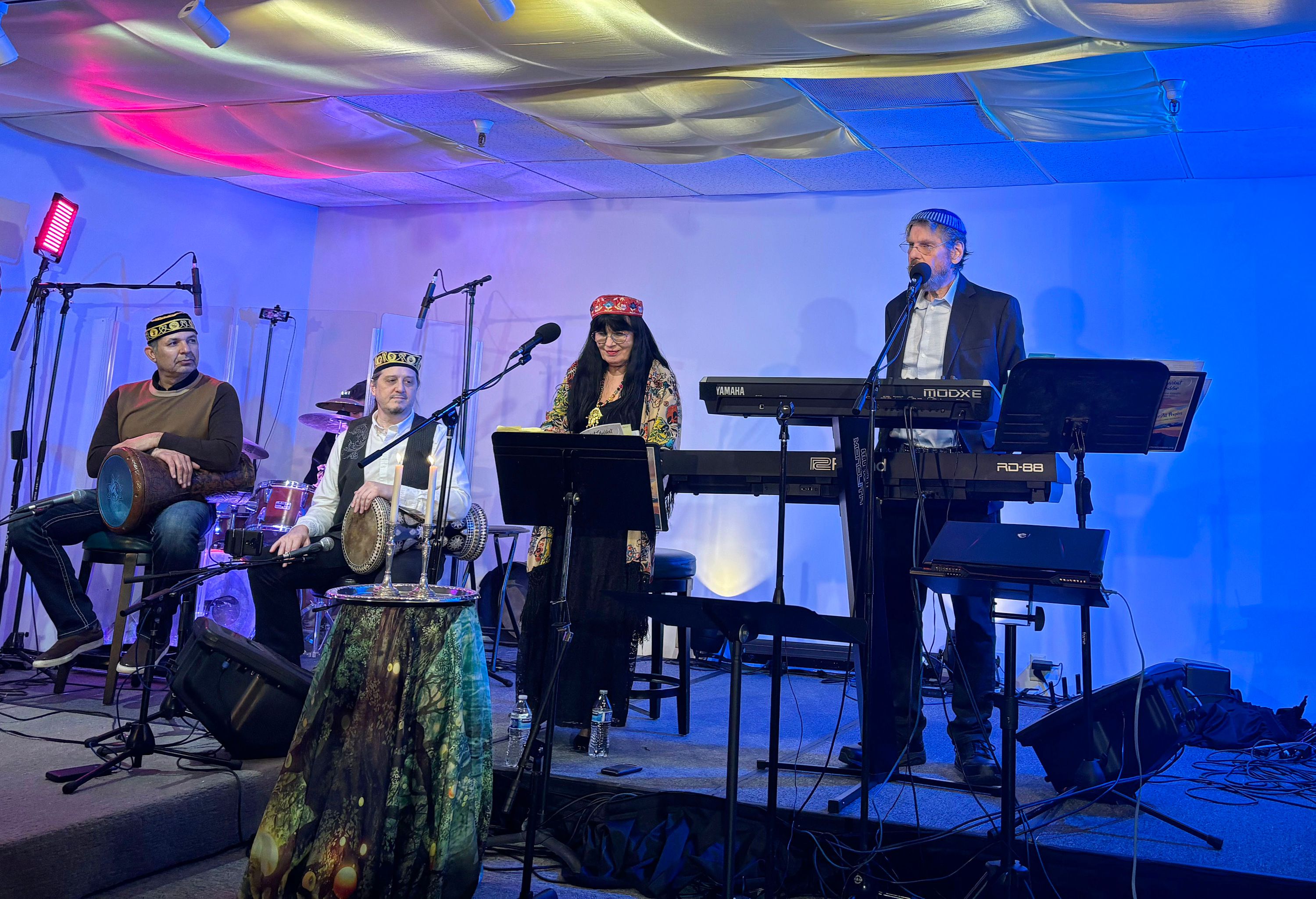 The House of Prayers for All Peoples held a music-filled Kabbalat Shabbat service on Feb. 9. Rabbi Alan Scott Bachman, right, gave his sermon while playing the keyboard alongside Rebbetzin Andalin Shekinah on the flute and vocals, Ricardo Romero on drums and Bryan Bale on percussion. The group also invited business professor Promothesh Chatterjee to give a lecture on Hindu teachings.
