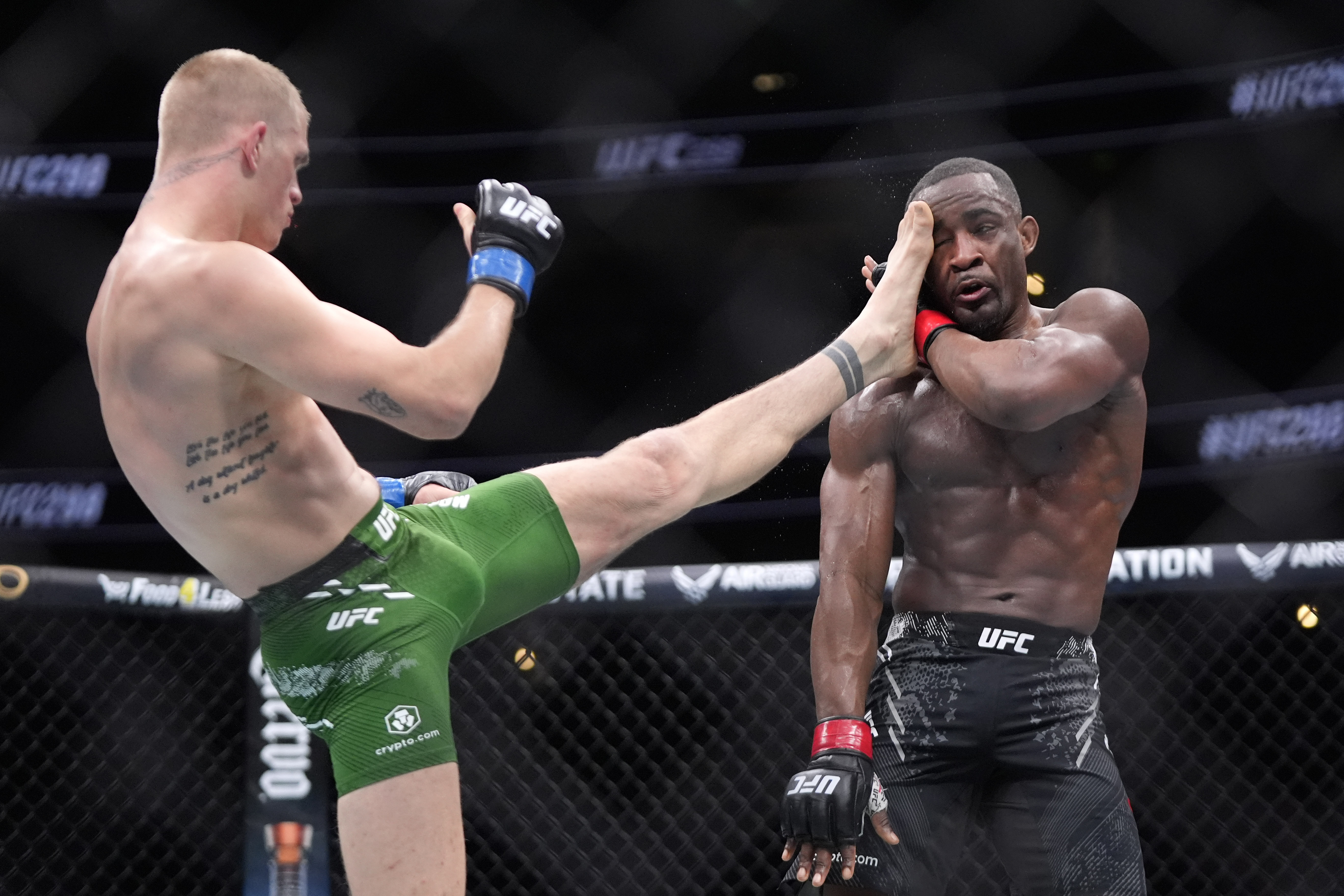 Ian Machado Garry, left, throws a kick to Geoff Neal during their welterweight bout at the UFC 298 mixed martial arts event Saturday, Feb. 17, 2024, in Anaheim, Calif. 
