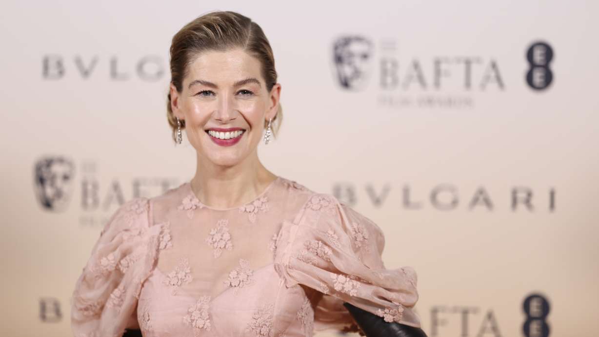Rosamund Pike poses for photographers upon arrival for the BAFTA Nominees Party in London, Saturday. Atom bomb epic "Oppenheimer" has won seven prizes, including best picture, at the British Academy Film Awards.
