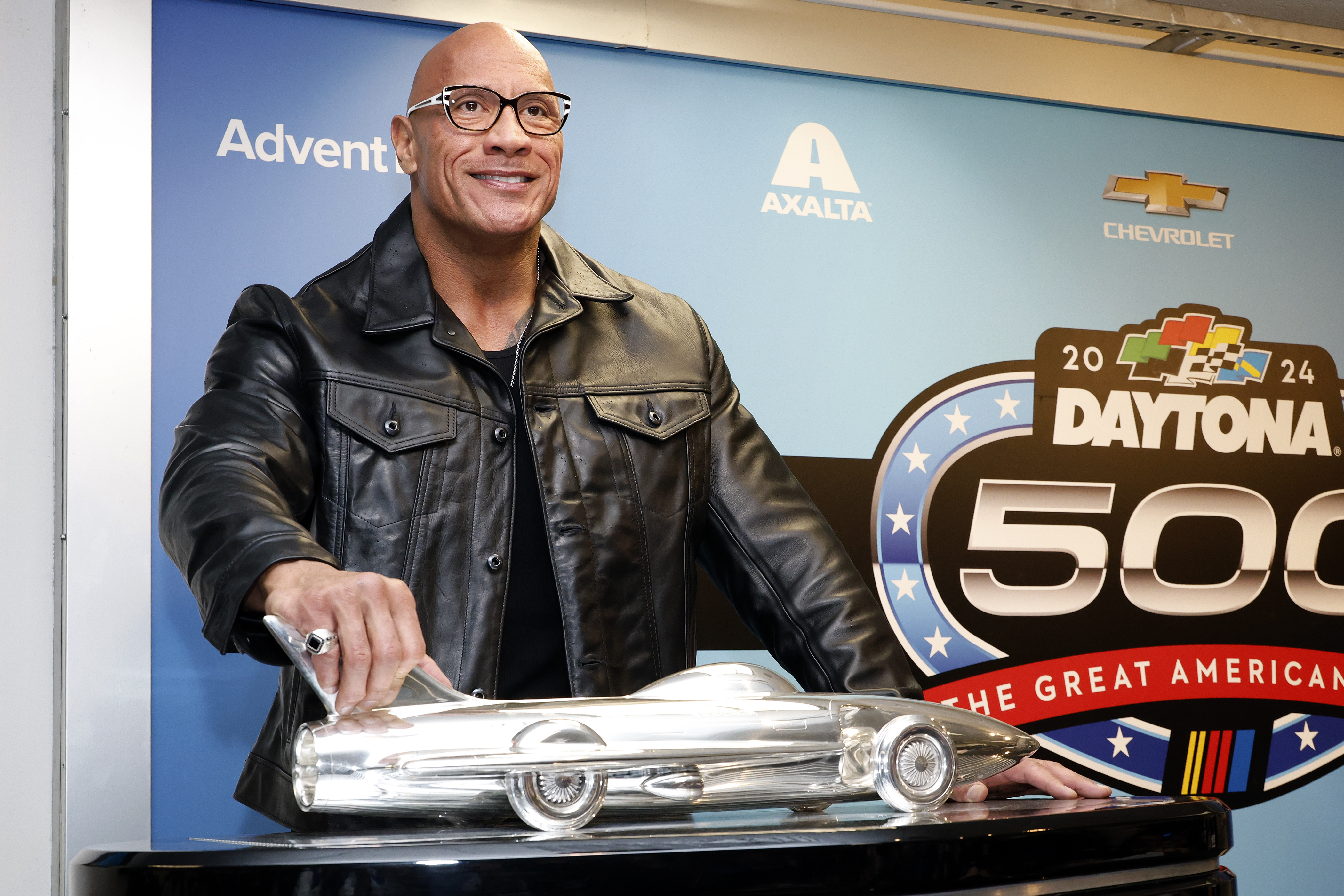 Grand Marshal Dwayne "The Rock" Johnson poses with the Harley J. Earl trophy after the NASCAR Daytona 500 auto race was postponed by rain Sunday, Feb. 18, 2024, at Daytona International Speedway in Daytona Beach, Fla. 