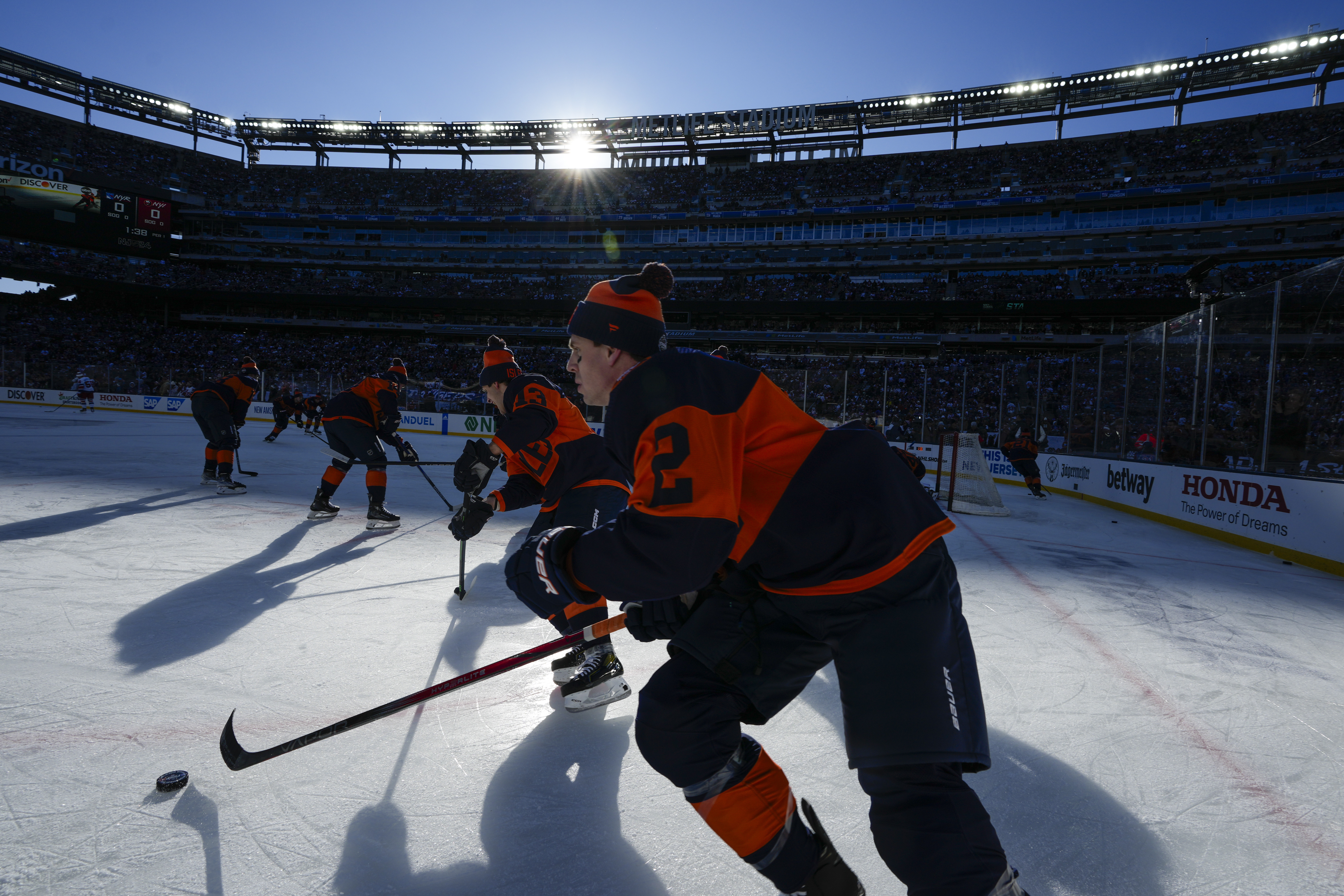 The New York Islanders warm up before an NHL Stadium Series hockey game against the New York Rangers in East Rutherford, N.J., Sunday, Feb. 18, 2024.