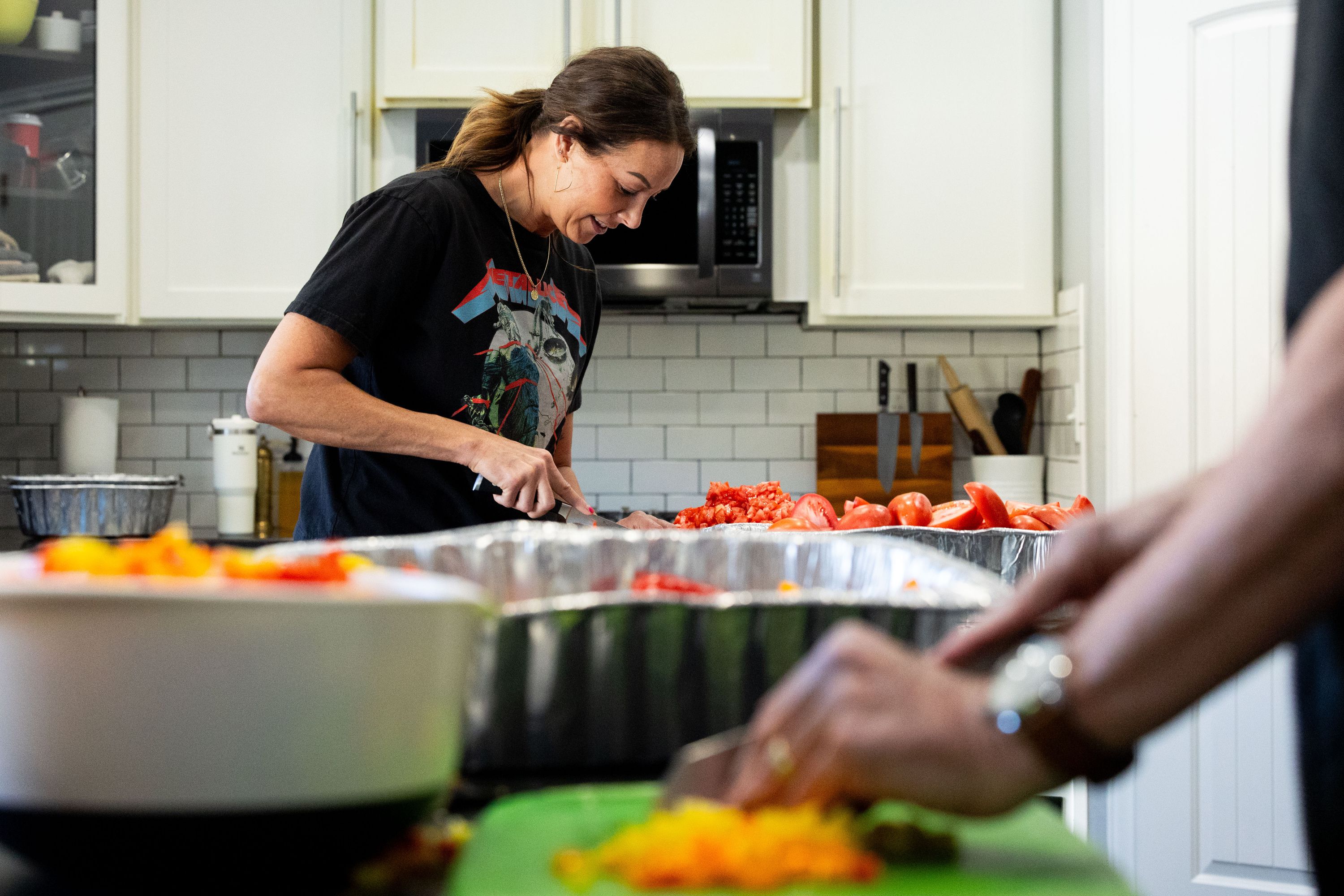 Jessica Lowe, founder of Be a Little Too Kind, dices tomatoes to make 100 plus portions of jambalaya at her home in Draper on Jan. 31. Be a Little Too Kind is a nonprofit organization focused on assisting those experiencing homelessness by providing a homemade meal every week and other essential life-sustaining items.