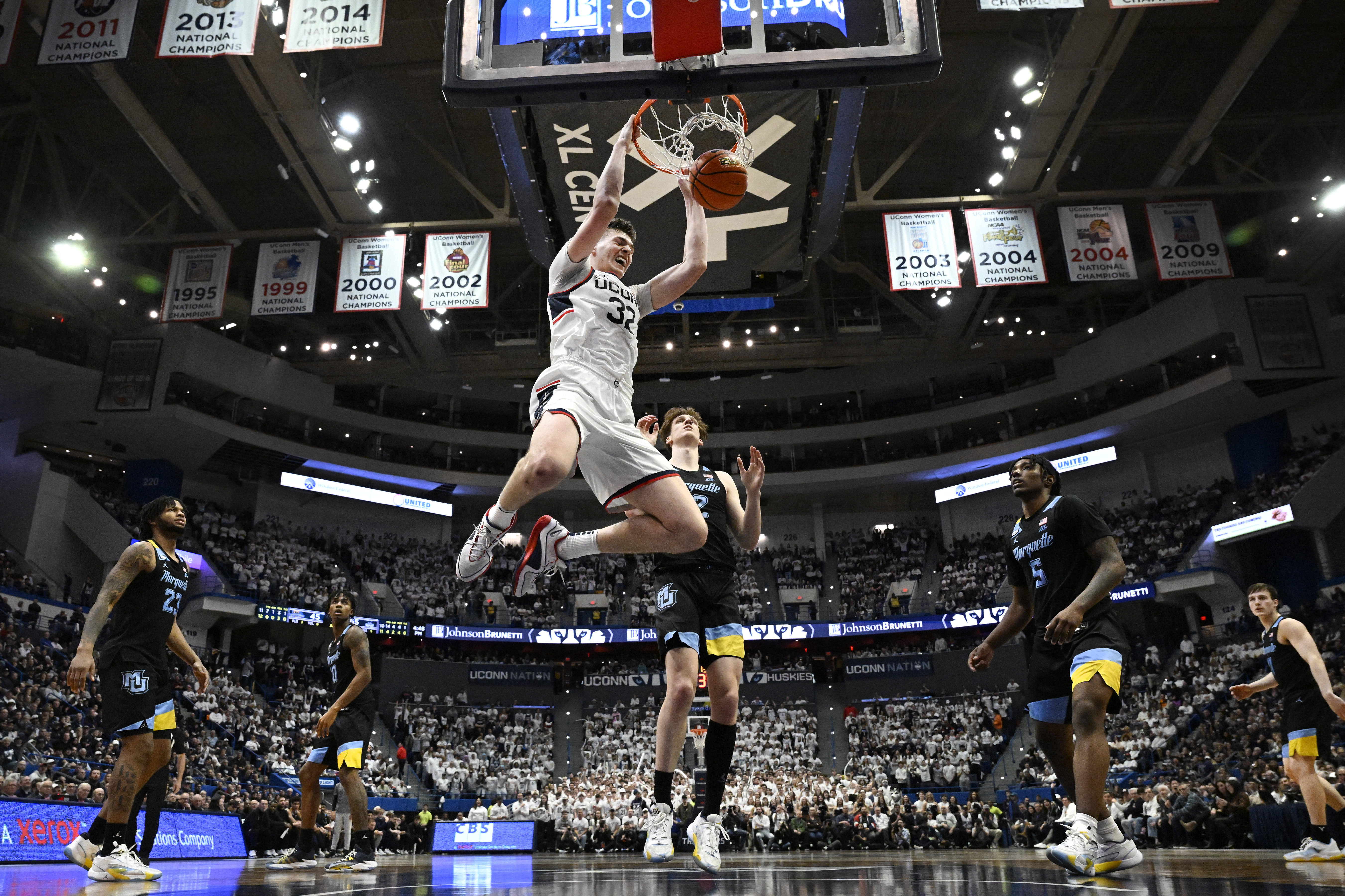 UConn center Donovan Clingan (32) dunks the ball in the second half of an NCAA college basketball game against Marquette, Saturday, Feb. 17, 2024, in Hartford, Conn. 