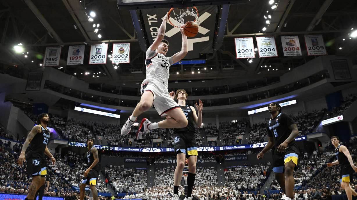 UConn center Donovan Clingan (32) dunks the ball in the second half of an NCAA college basketball game against Marquette, Saturday, Feb. 17, 2024, in Hartford, Conn.