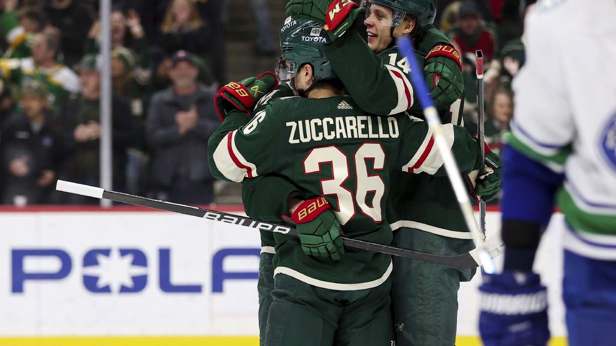 Minnesota Wild center Joel Eriksson Ek is congratulated for his hat-trick against the Vancouver Canucks during the third period of an NHL hockey game, Monday, Feb. 19, 2024, in St. Paul, Minn.