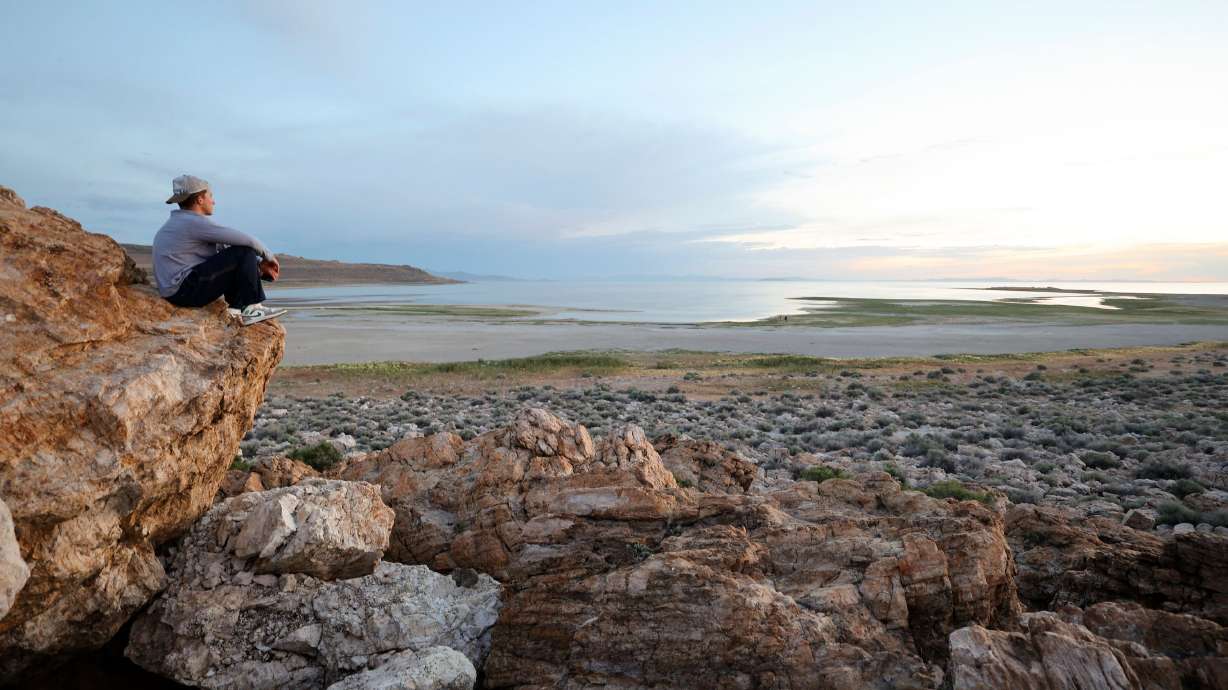 Aleks Kupe watches the sunset over the Great Salt Lake from Ladyfinger Point on Antelope Island on June 5, 2023. A bill introduced last week would transfer the ownership of parcels of federal land to the state at no cost.