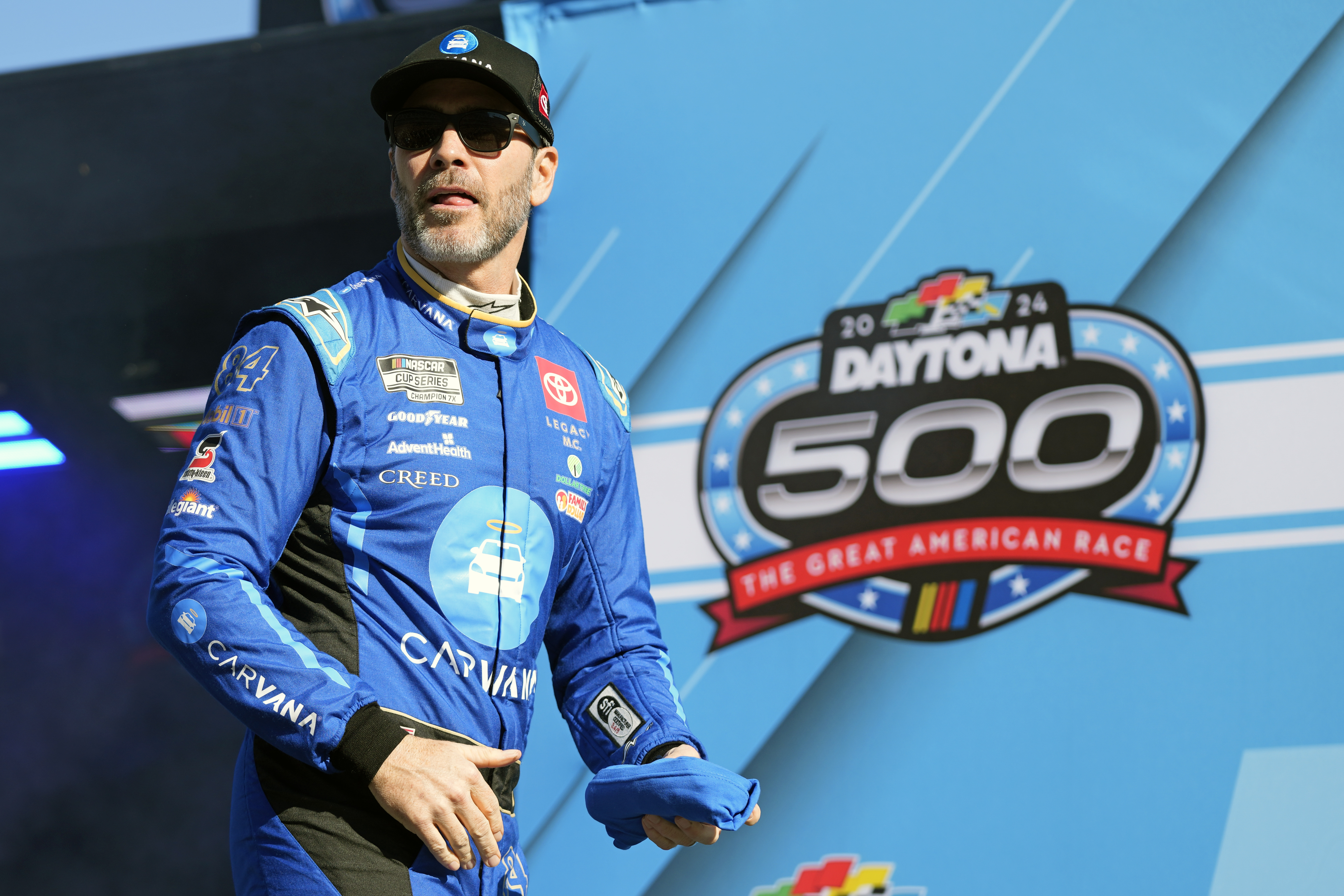 Jimmie Johnson walks across the stage during driver introductions during the NASCAR Daytona 500 auto race at Daytona International Speedway, Monday, Feb. 19, 2024, in Daytona Beach, Fla.