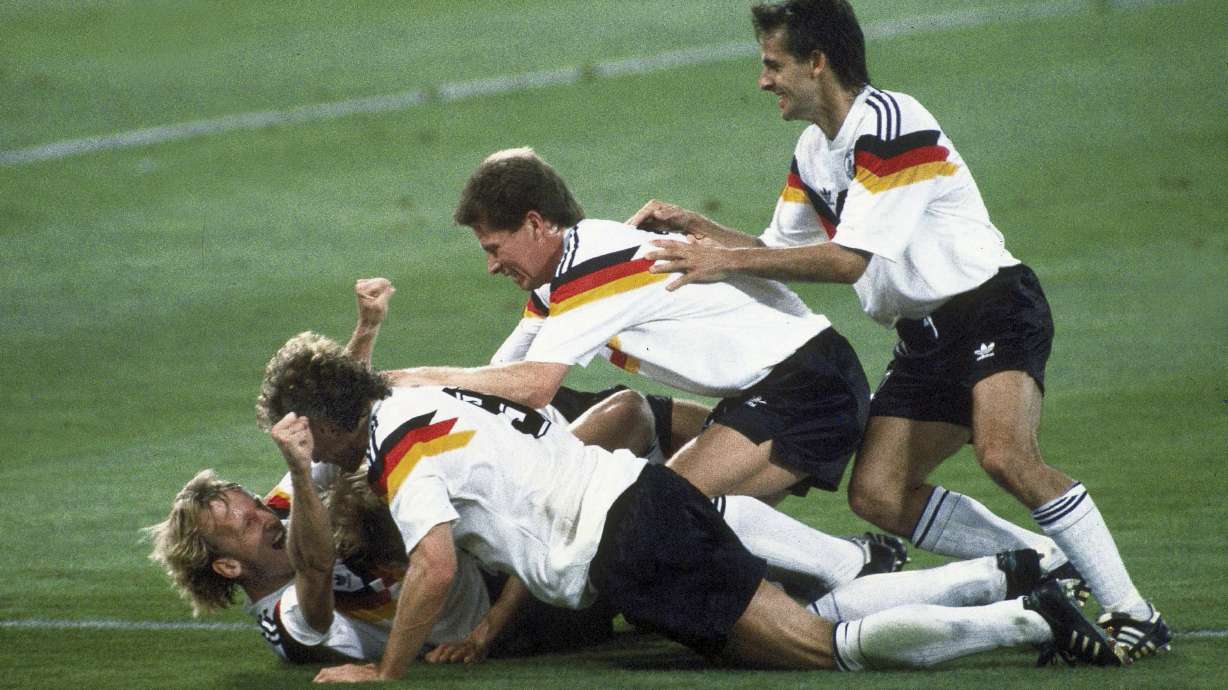 FILE - Germany players celebrate after Andreas Brehme, left on ground, scores the winning goal in the World Cup soccer final match against Argentina, in the Olympic Stadium, in Rome, July 8, 1990. Andreas Brehme, who scored the only goal as West Germany beat Argentina to win the 1990 World Cup final, has died. He was 63. Brehme’s partner Susanne Schaefer has confirmed his death in a statement to Germany’s dpa news agency.