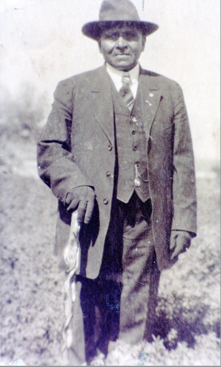 Frank Timbimboo Warner, standing in the spot where his mother was killed in the Bear River Massacre, 1918.