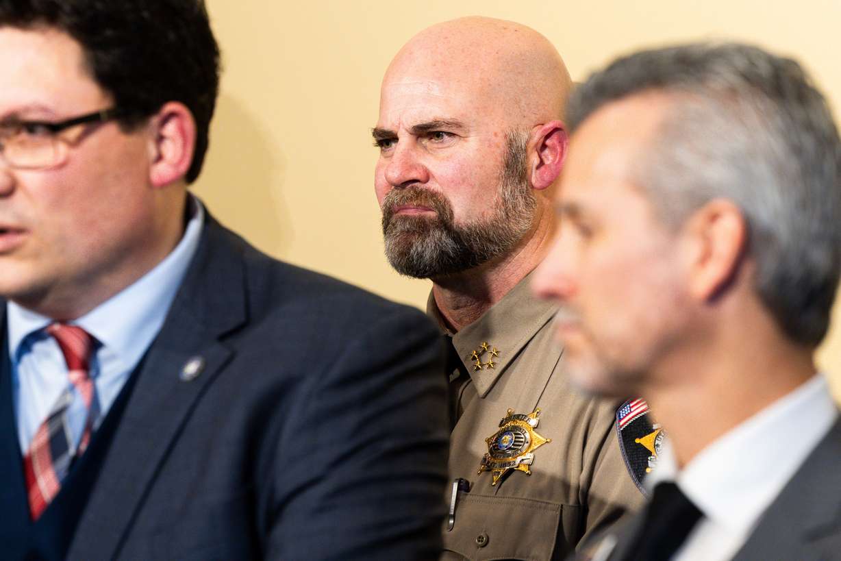 Utah County Sheriff Mike Smith, center, becomes emotional as Rep. Ryan Wilcox, R-Ogden, speaks at a press conference held to discuss the School Security Task Force at the Utah Capitol in Salt Lake City on Tuesday. Wilcox was joined by lawmakers, law enforcement officials, experts, parents and others to discuss the task force and related legislation.