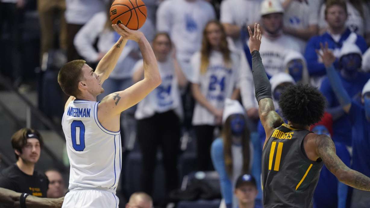 BYU forward Noah Waterman (0) shoots as Baylor forward Jalen Bridges (11) defends during the first half of an NCAA college basketball game Tuesday, Feb. 20, 2024, in Provo, Utah.