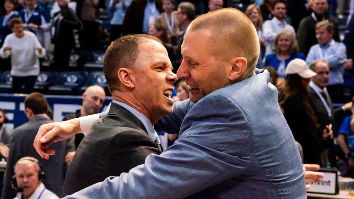 Left to right, Brigham Young assistant coach Nick Robinson hugs Brigham Young head coach Mark Pope after their victory 78-71 over Baylor University in a men’s college basketball game at the Marriott Center in Provo on Tuesday, Feb. 20, 2024.