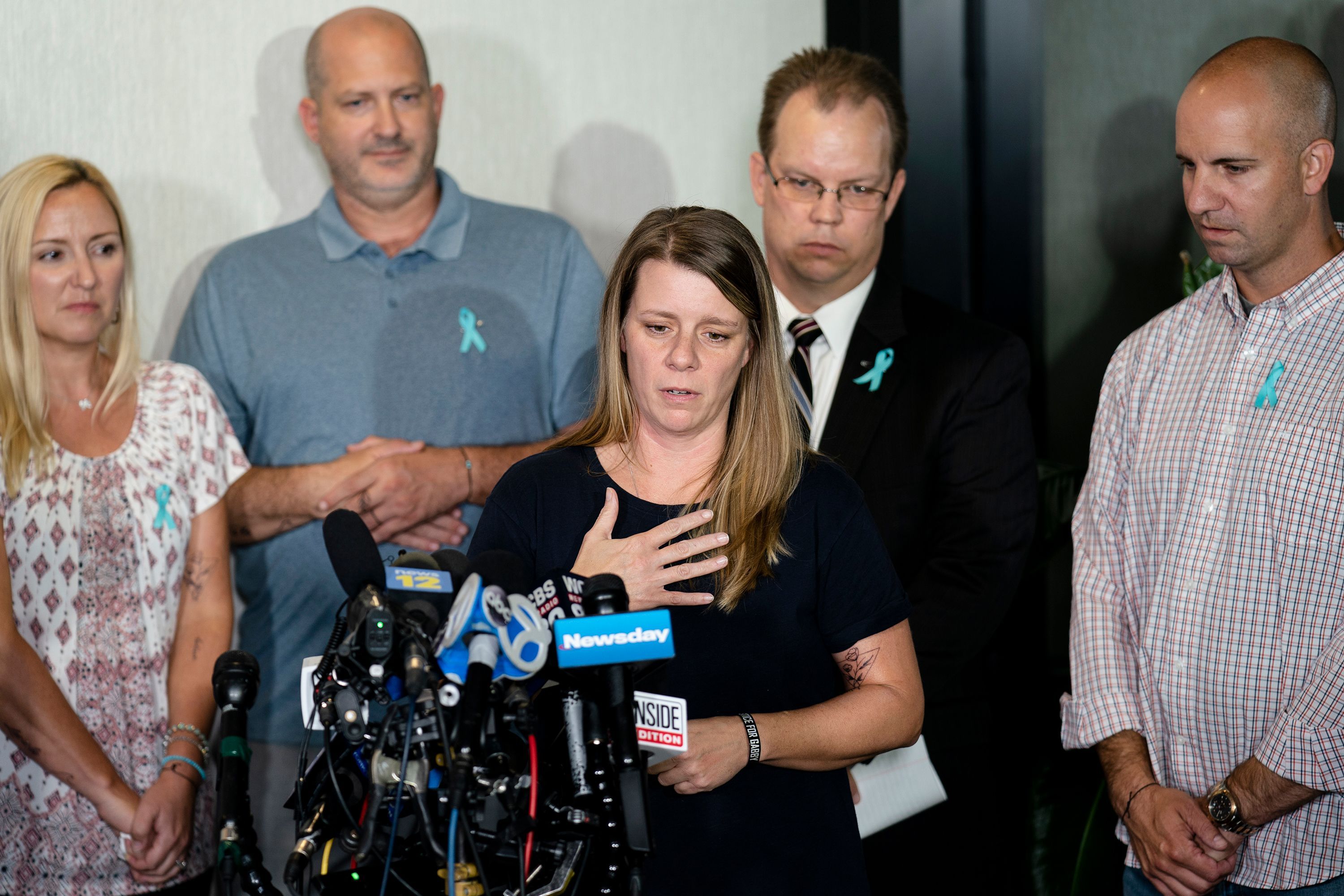 Nichole Schmidt, mother of Gabby Petito, speaks alongside Tara Petito, Petito's stepmother; Joseph Petito, her father; Richard Stafford, the family's attorney; and Jim Schmidt, her stepfather; in September 2021 in Bohemia, New York.