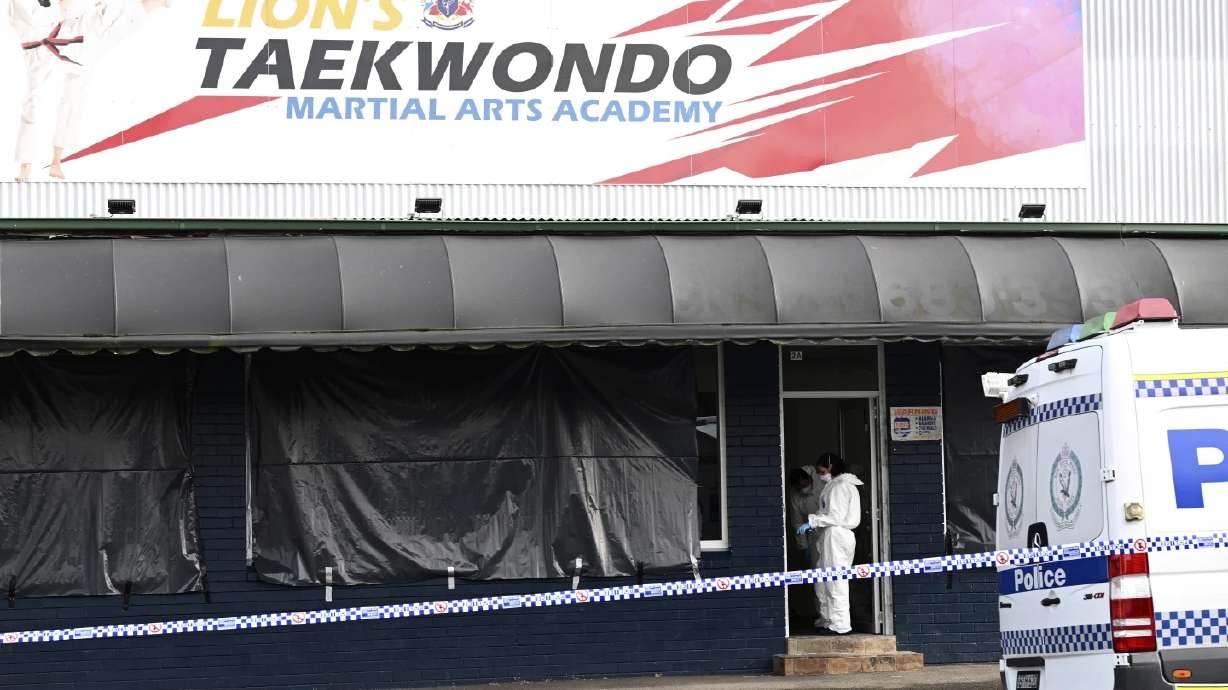 Police investigate a crime scene in Sydney, Australia, on Wednesday. Police say a taekwondo instructor killed a 7-year-old student and the boy's parents.