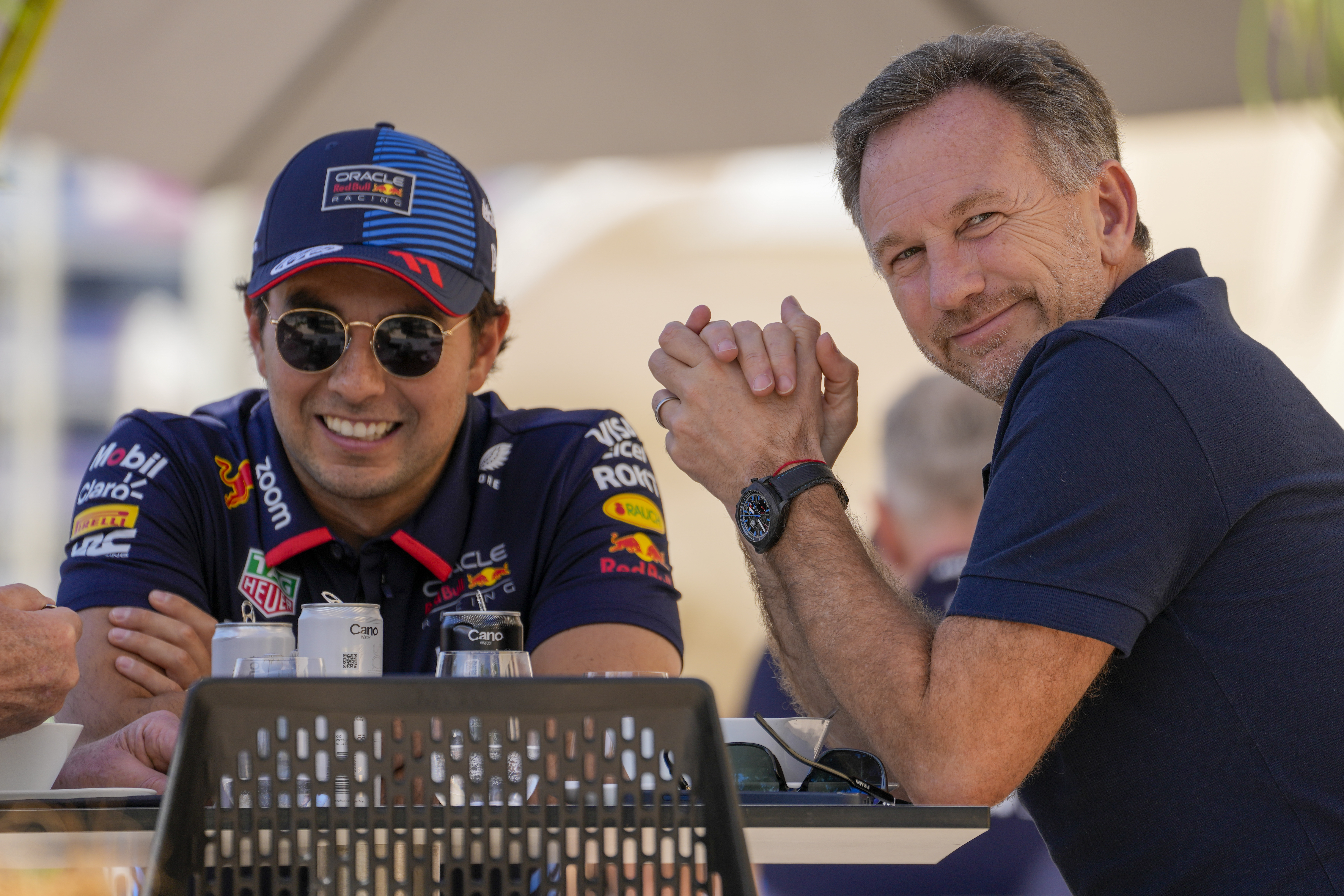 Red Bull team principal Christian Horner, right, chats with Red Bull driver Sergio Perez of Mexico at the pits during Formula One pre season test at the Bahrain International Circuit in Sakhir, Bahrain, Wednesday, Feb. 21, 2024. 