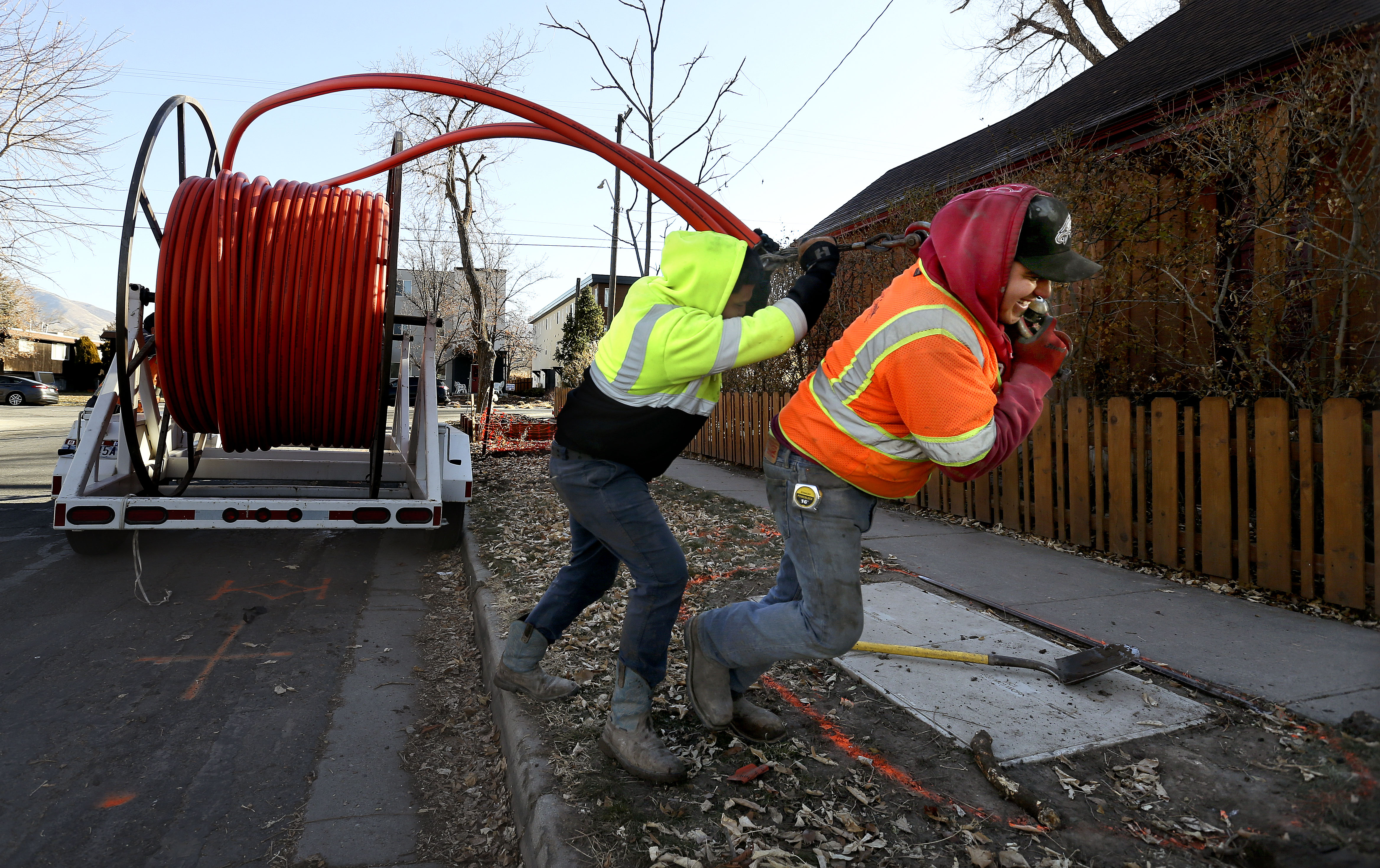 LightLink Communications workers install cable for broadband internet in Salt Lake City on Dec. 3, 2020. Utah-based UTOPIA Fiber on Tuesday released 2023 numbers that signify a record number of buildouts and growth for the internet network.