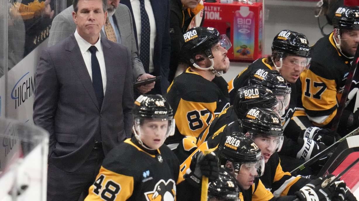 Pittsburgh Penguins head coach Mike Sullivan, left, stands behind his bench during the first period of an NHL hockey game against the New York Islanders in Pittsburgh, Tuesday, Feb. 20, 2024.