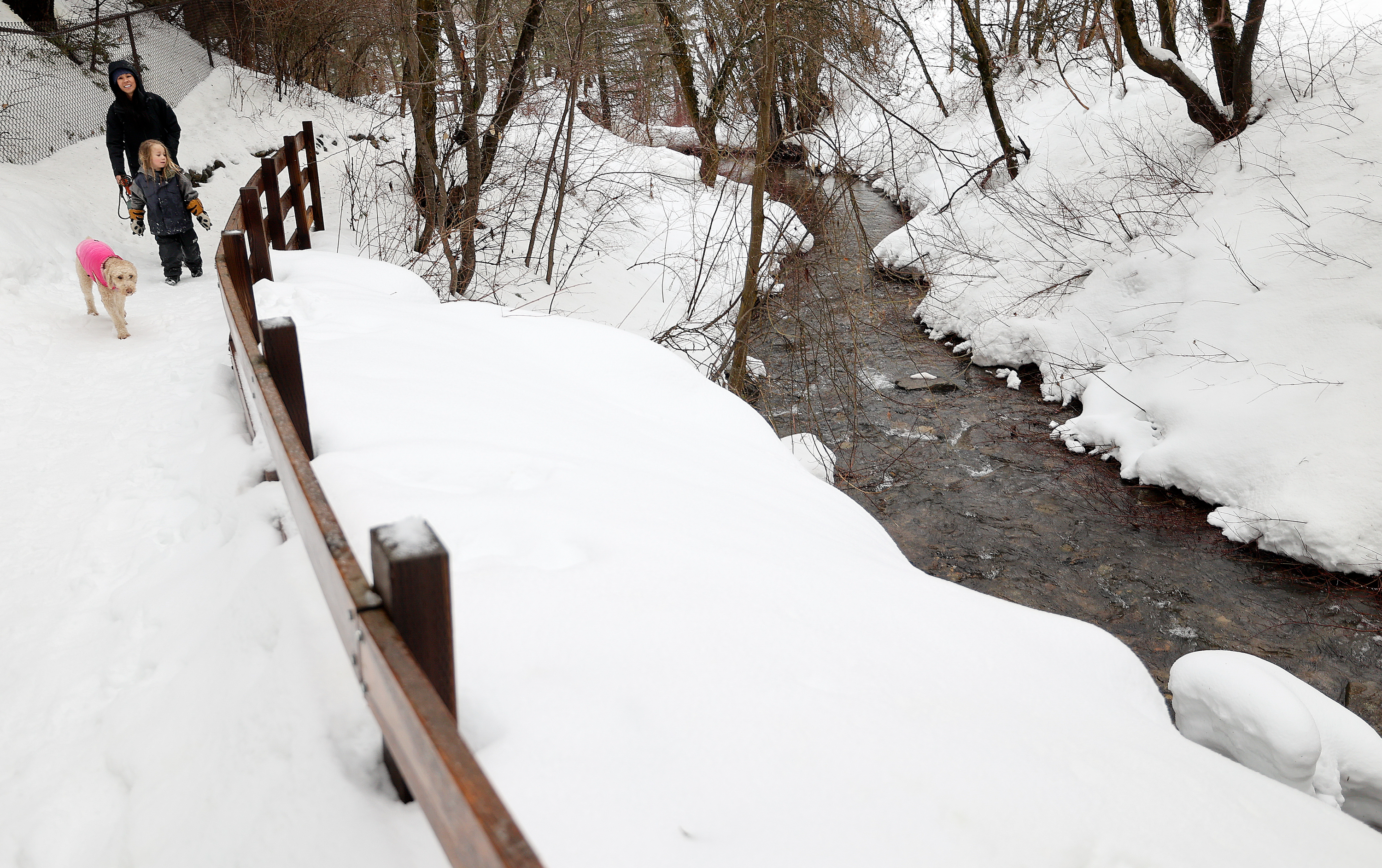 Kathy White and Jasper White walk with their dog Jane in Millcreek Canyon on Wednesday.