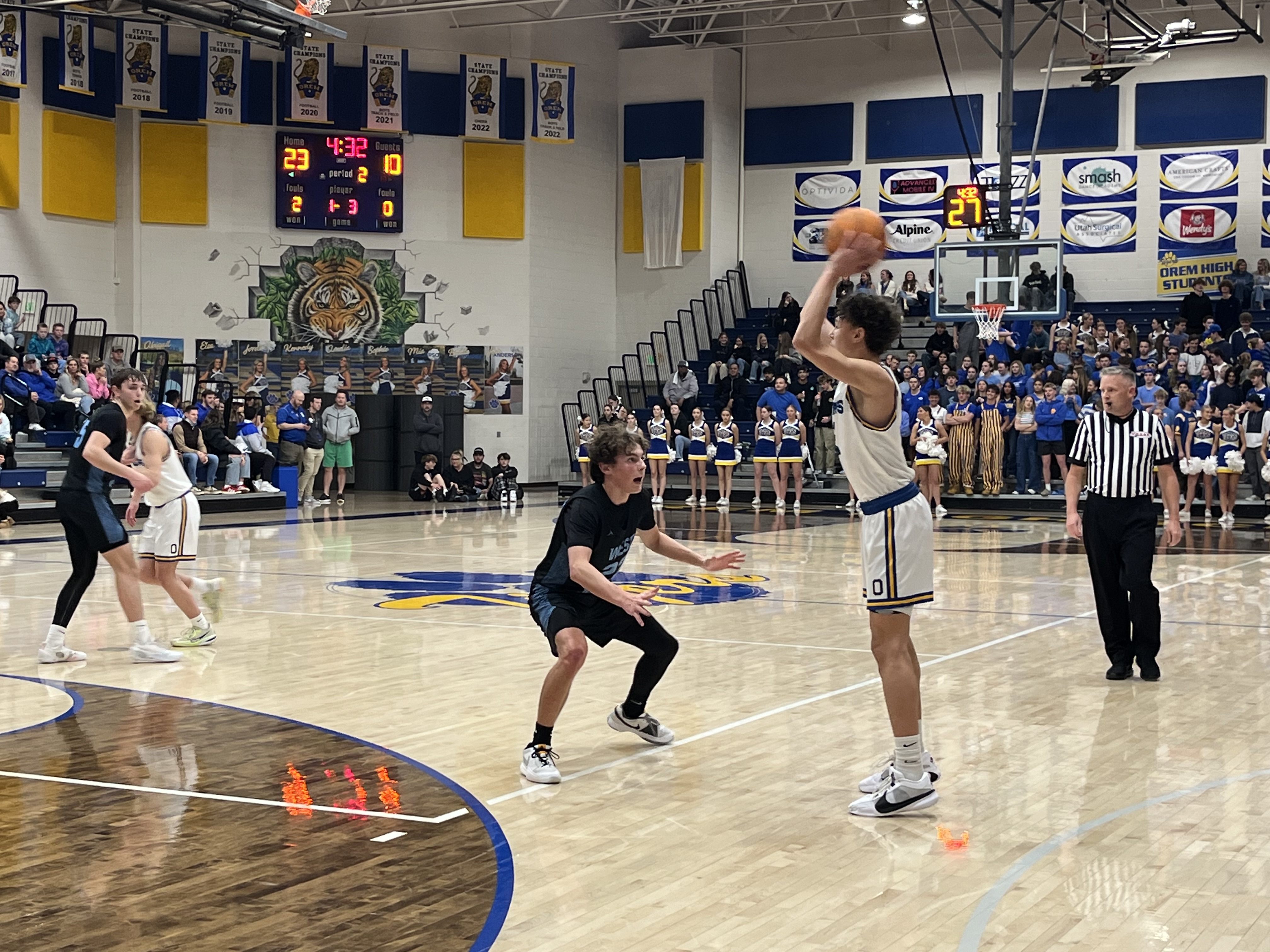 Orem's Jax Allen holds the ball out front against West Jordan's Steven Cox.