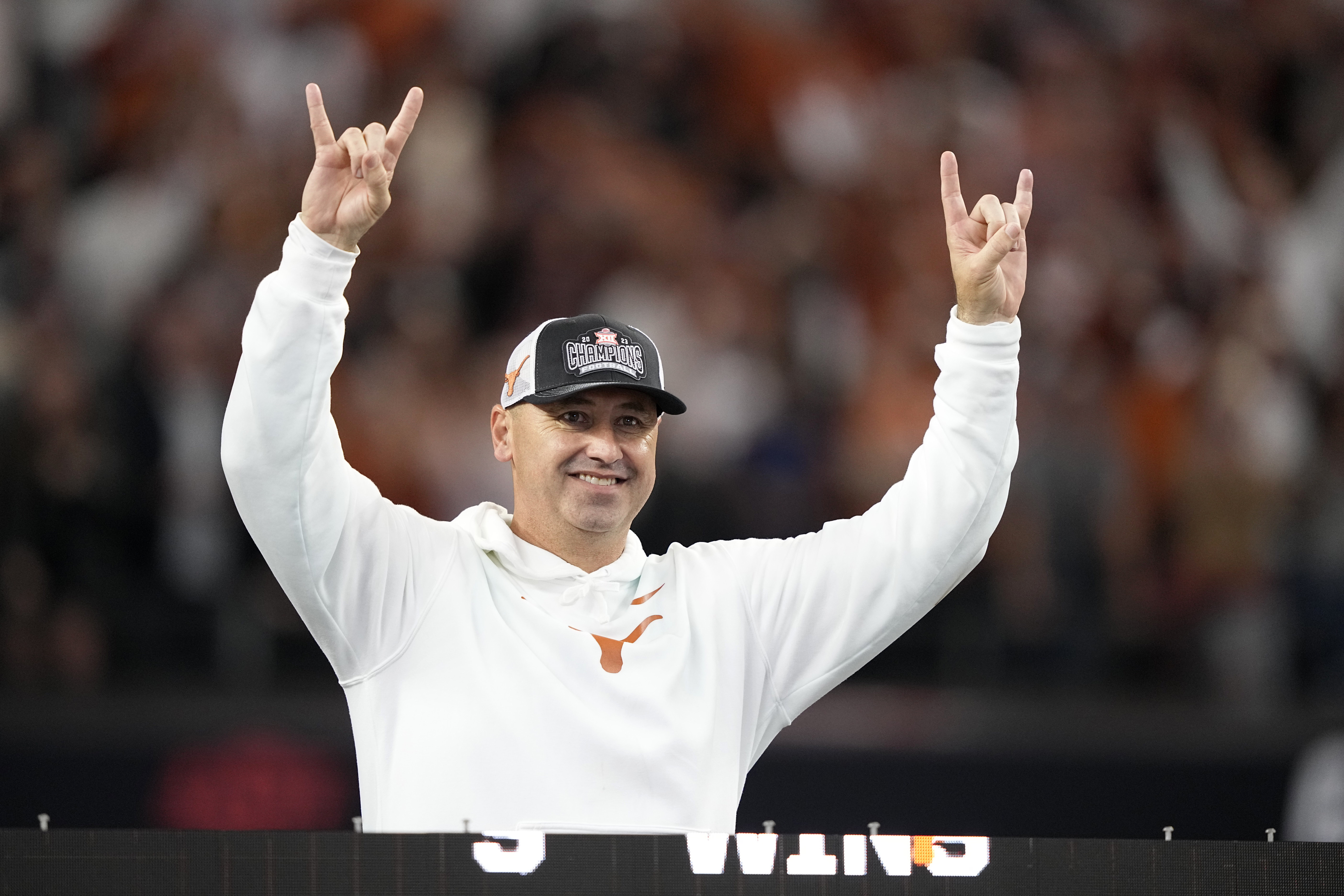 FILE - Texas head coach Steve Sarkisian celebrates after his team won the Big 12 Conference championship NCAA college football game against Oklahoma State in Arlington, Texas, Saturday, Dec. 2, 2023. Sarkisian’s contract extension will push his guaranteed salary to $10.3 million this year under details released by the school's Board of Regents. That will make him one of the highest paid coaches in the country after leading the Longhorns to the Big 12 championship and their first appearance in the College Football Playoff.
