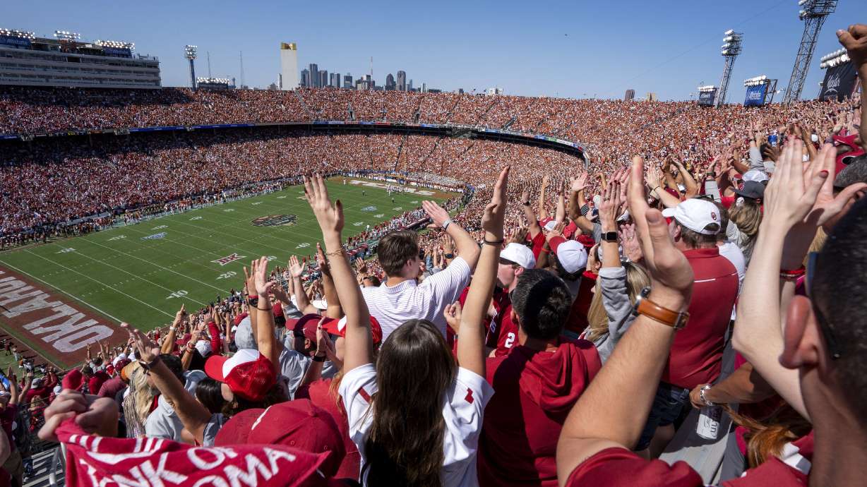Oklahoma fans celebrate a touchdown during the first half of an NCAA college football game against Texas at the Cotton Bowl, Saturday, Oct. 7, 2023, in Dallas. The ESPN “College GameDay” analyst Kirk Herbstreit and the network's broadcaster Chris Fowler announced Thursday, Feb. 22, 2024, on social media they will be voices in EA Sports' upcoming college football video game.