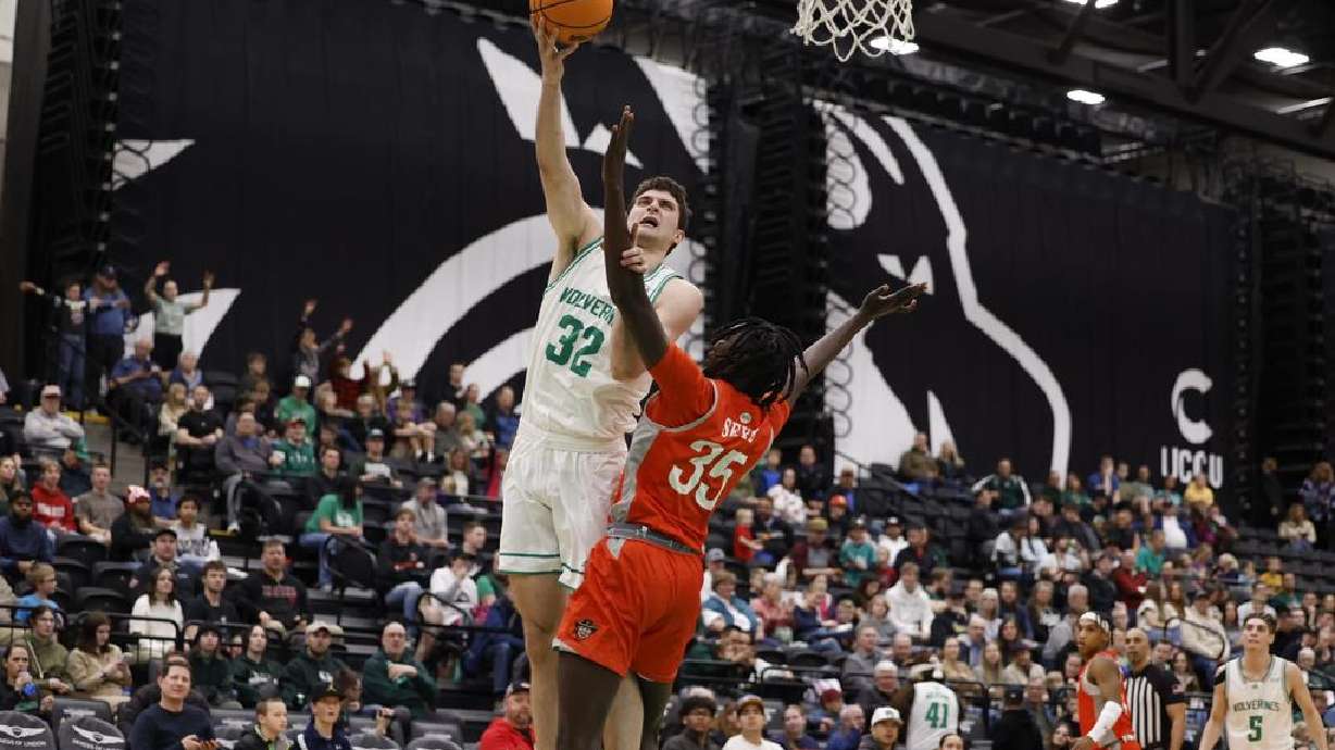 Utah Valley's Trevin Dorius (32) shoots over UTRGV's Saliou Saye (35) Thursday night at UCCU Center.