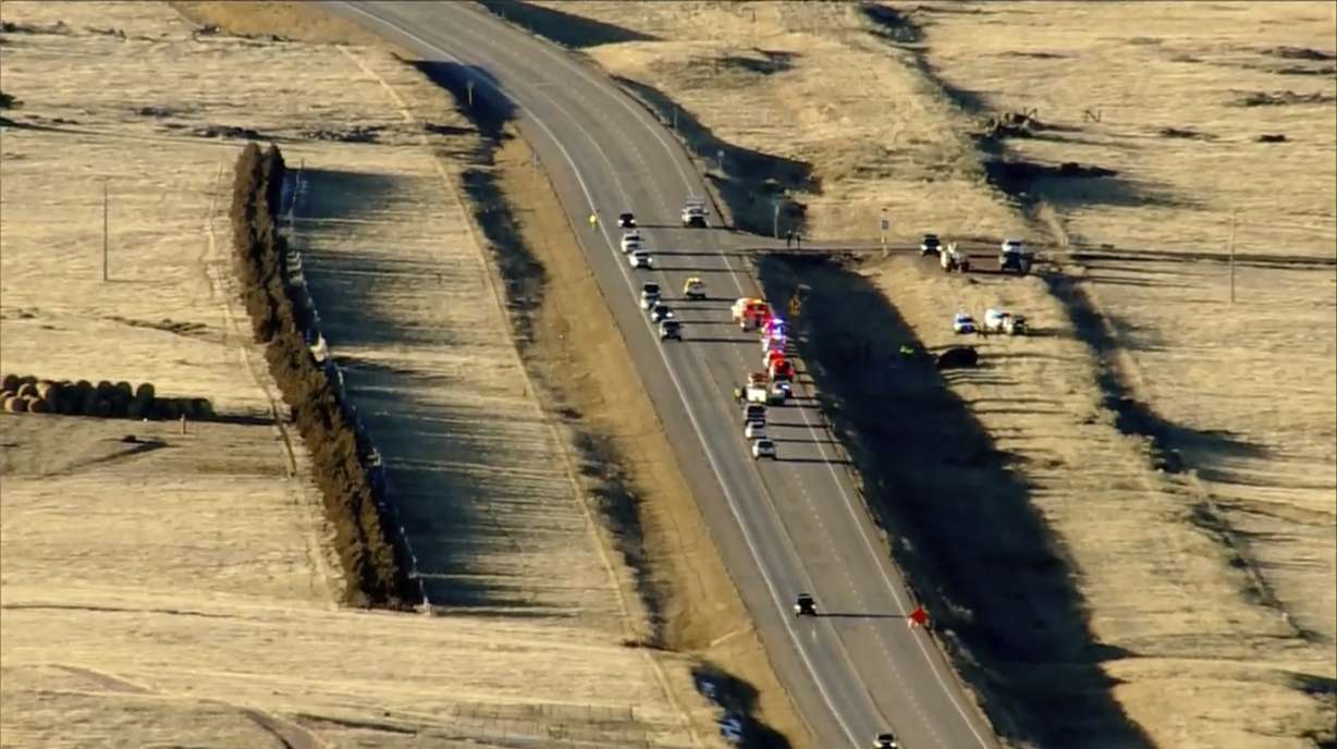 Emergency responders investigate the scene of a crash, Thursday on U.S. 287 about 10 miles south of the Wyoming-Colorado line between Laramie and Fort Collins, Colo.