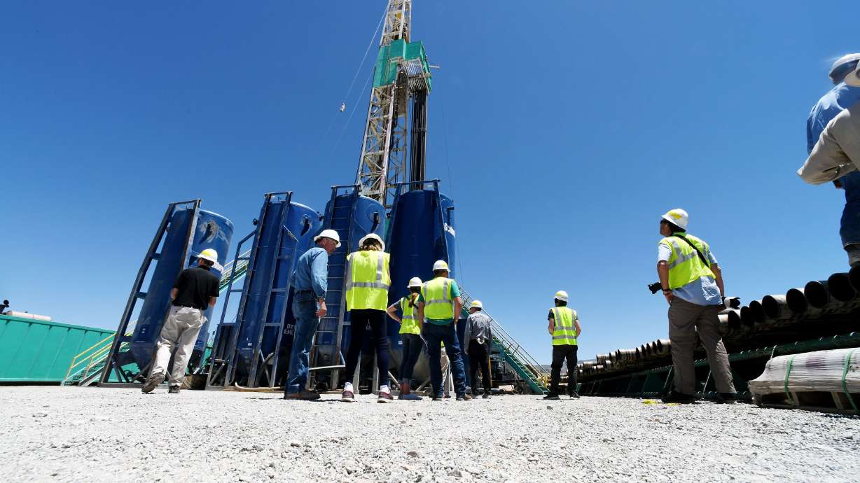 A group of media watch crew men work during a tour of a drilling rig at the FORGE geothermal demonstration site near Milford on July 6, 2023.