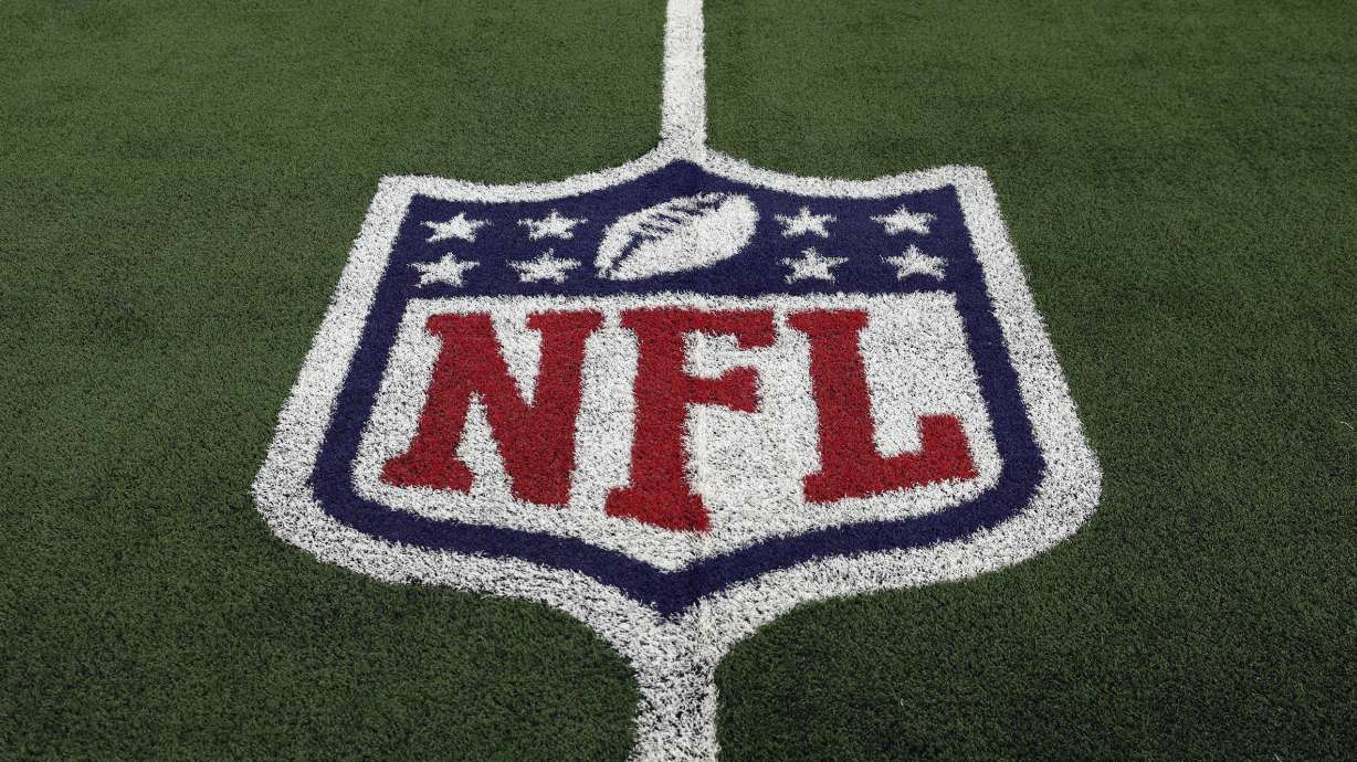 FILE - The NFL logo is shown on the field before an NFL football game between the Detroit Lions and the Dallas Cowboys, Saturday, Dec. 30, 2023, in Arlington, Texas. The NFL’s salary cap for 2024 will be $255.4 million, up a record $30.6 million from last year.