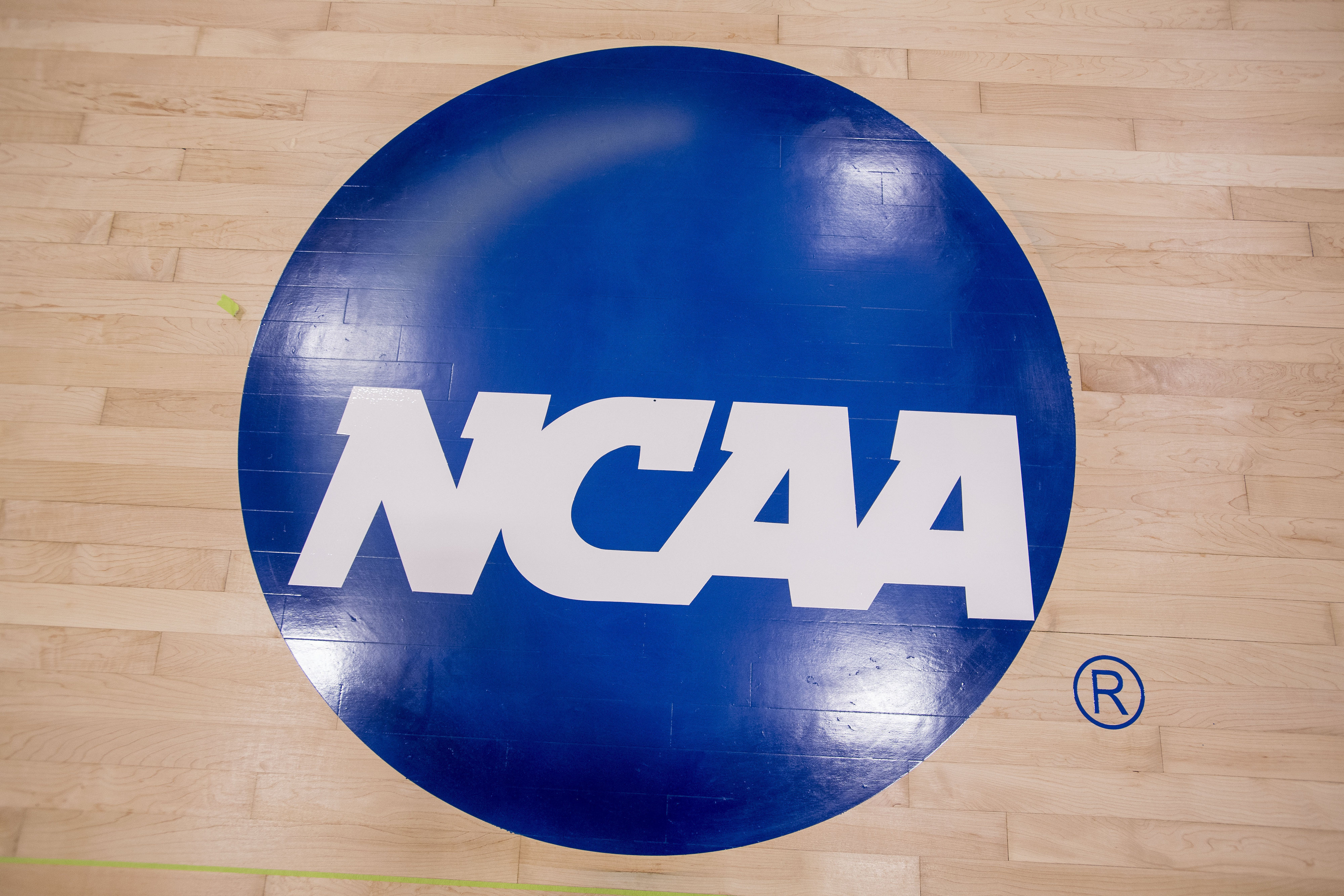 FILE - The new NCAA logo that was painted on the Concordia University Irvine basketball court is seen in Irvine, Calif., Friday, May 19, 2017. Prompted by new legislation emphasizing individual accountability in NCAA rules violations cases, the Committee on Infractions has outlined potential penalties for rules-breakers in leadership positions beyond the coaching staff, up to and including school presidents.