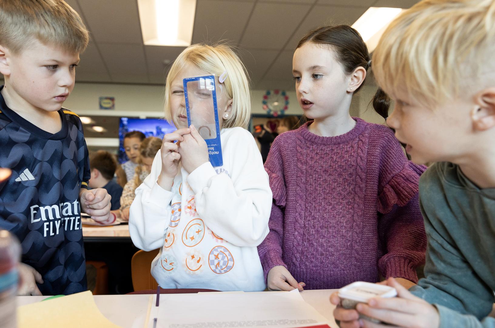 Finn Harrison, Quinn Page, Claire Johnson, and Brooks Holt decipher soil samples during a visit by the FBI at Canyon Creek Elementary in Farmington where second graders were taught how to use detective skills on Friday.
