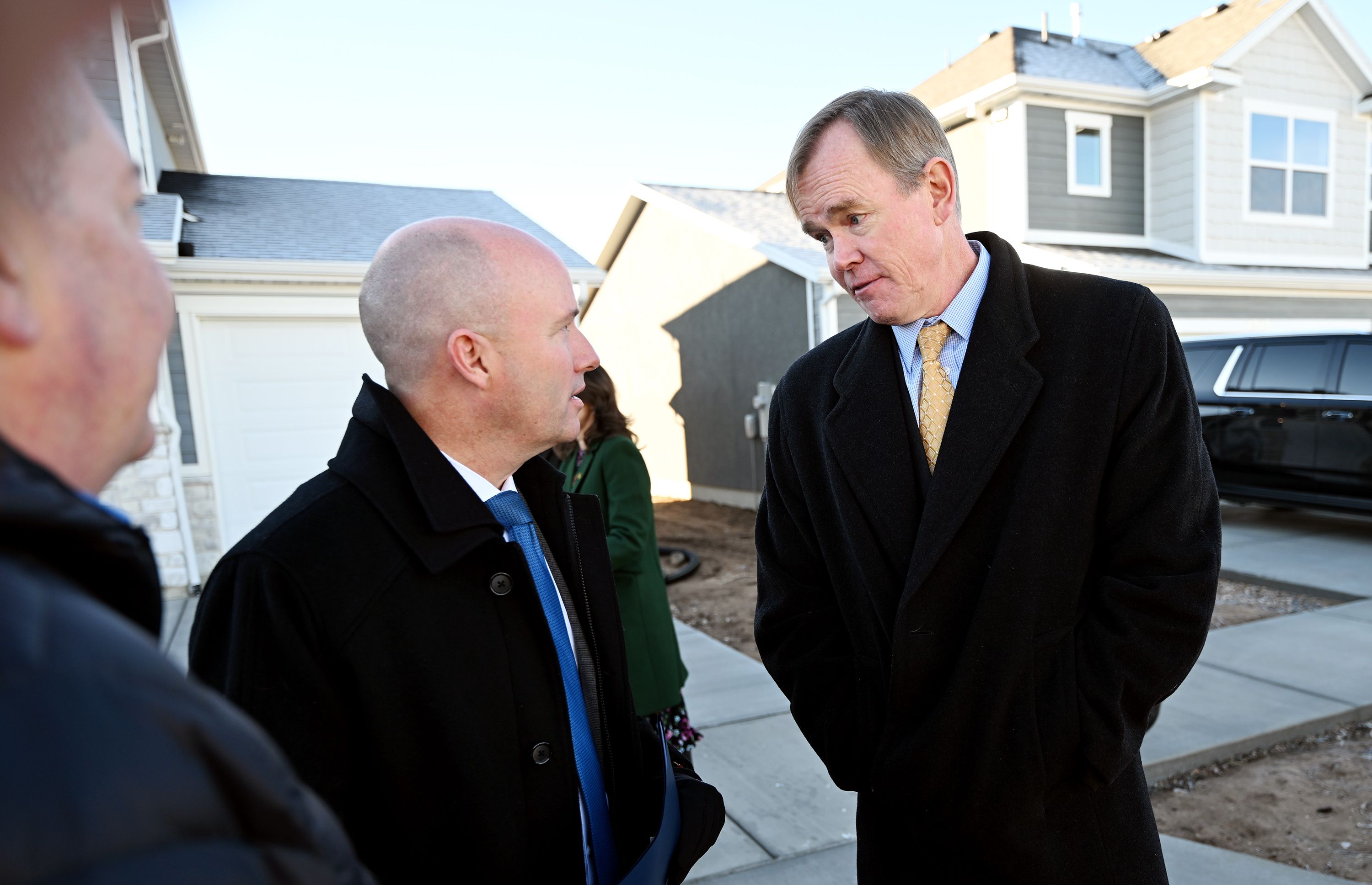Gov. Spencer Cox talks with Steve Waldrip, who was introduced as the senior adviser for housing strategy and innovation prior in West Haven on Dec. 5, 2023.