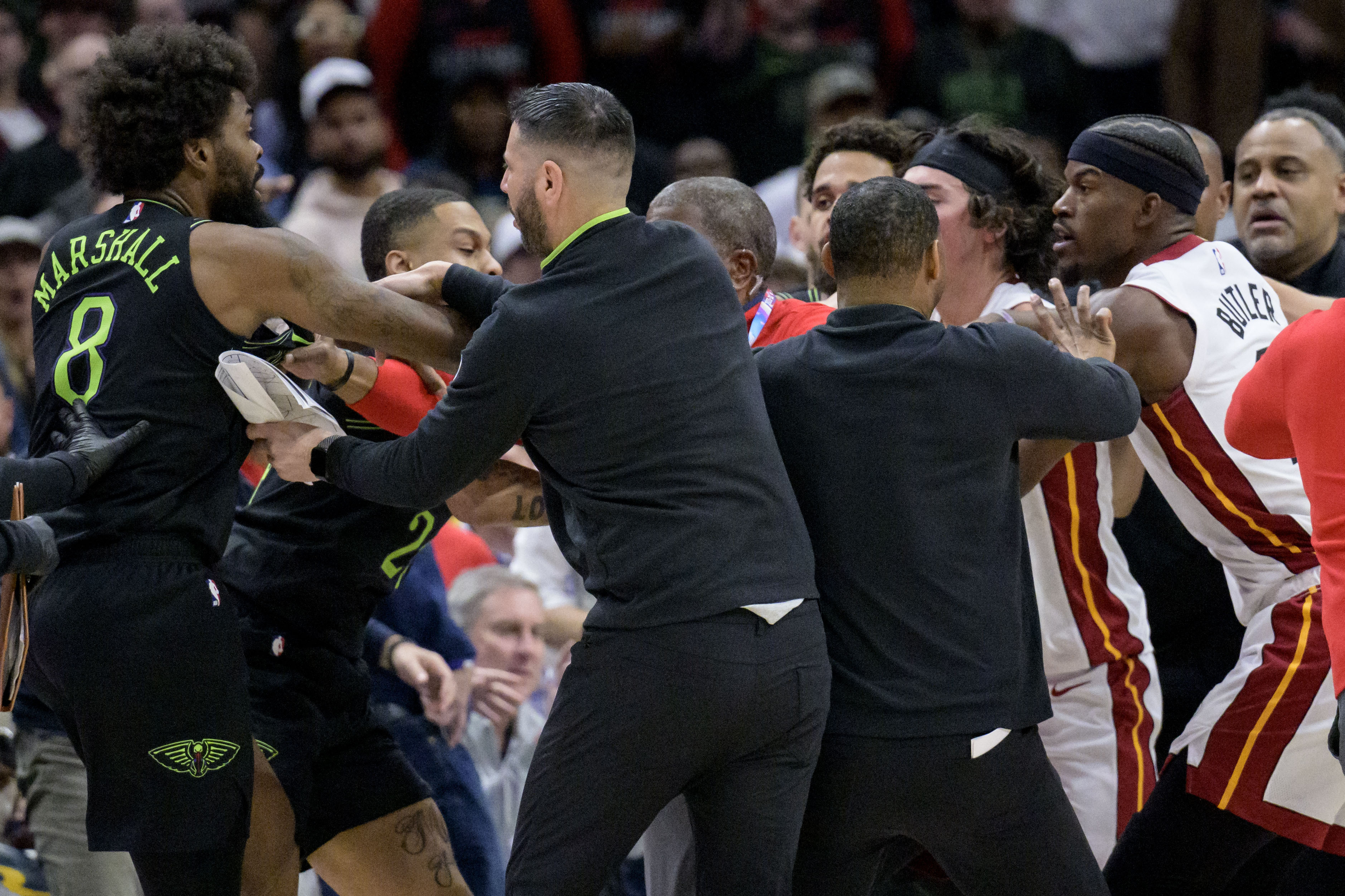 New Orleans Pelicans forward Naji Marshall (8), left, and Miami Heat forward Jimmy Butler, right, get into a scuffle during the second half of an NBA basketball game in New Orleans, Friday, Feb. 23, 2024. Marshall and Butler were later ejected.
